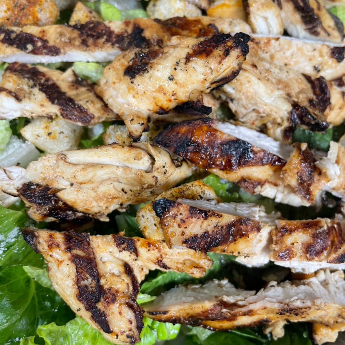 Order Caesar Salad with Grilled Chicken - Salad food online from Davila's Pizza & Restaurant store, Hackettstown on bringmethat.com