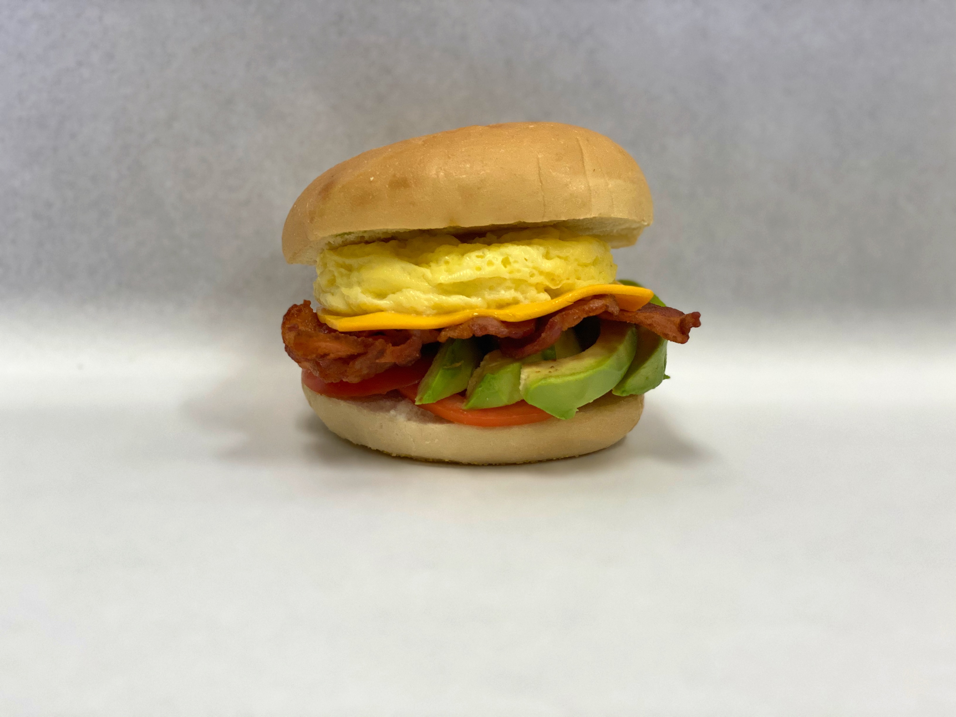 Order 21A. Bacon, Egg, Tomato, Avocado & Cheese food online from Bagel Place Cafe store, Sunnyvale on bringmethat.com