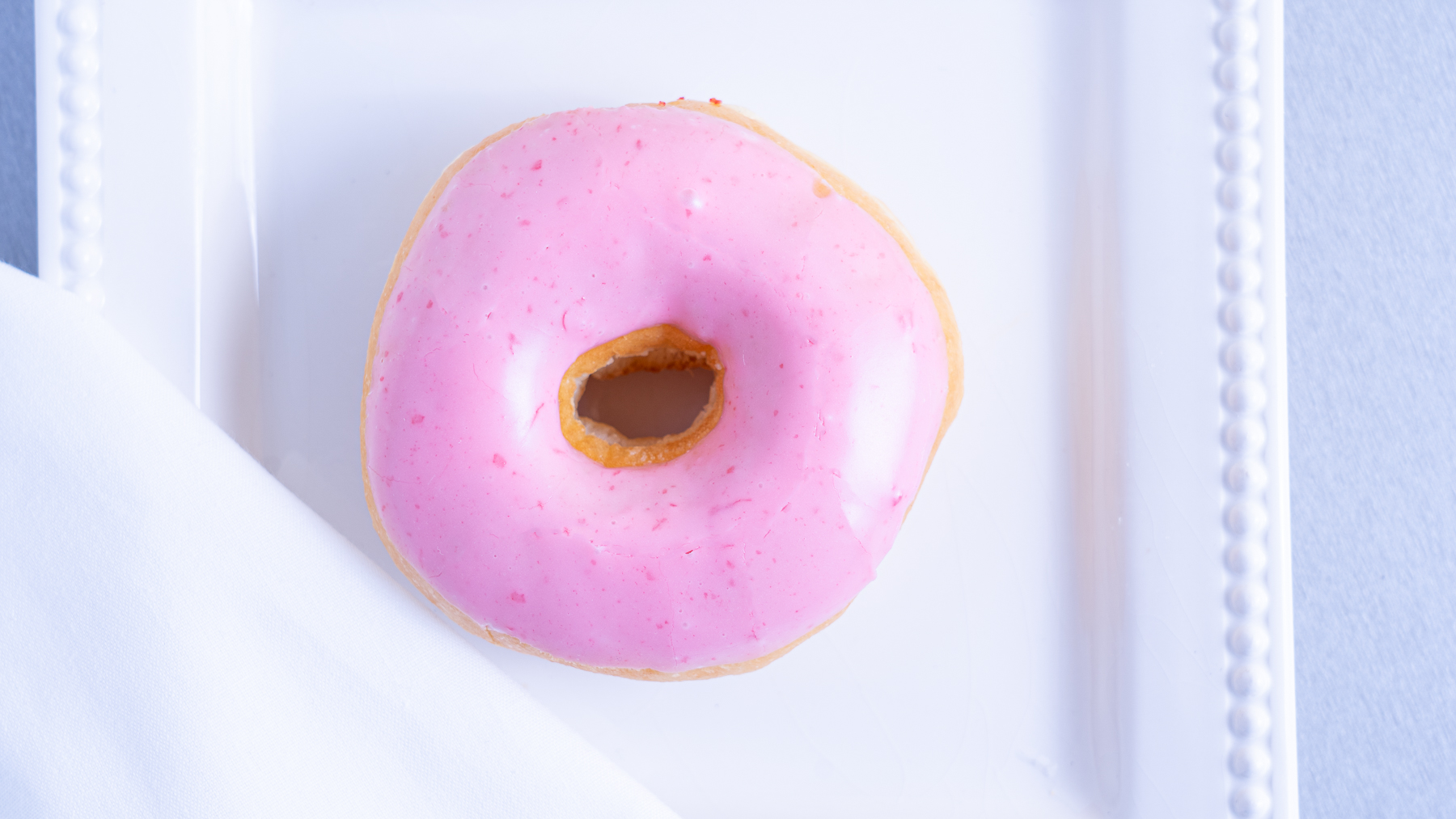 Order Colored Donut food online from Bakers Dozen Donuts store, Sachse on bringmethat.com