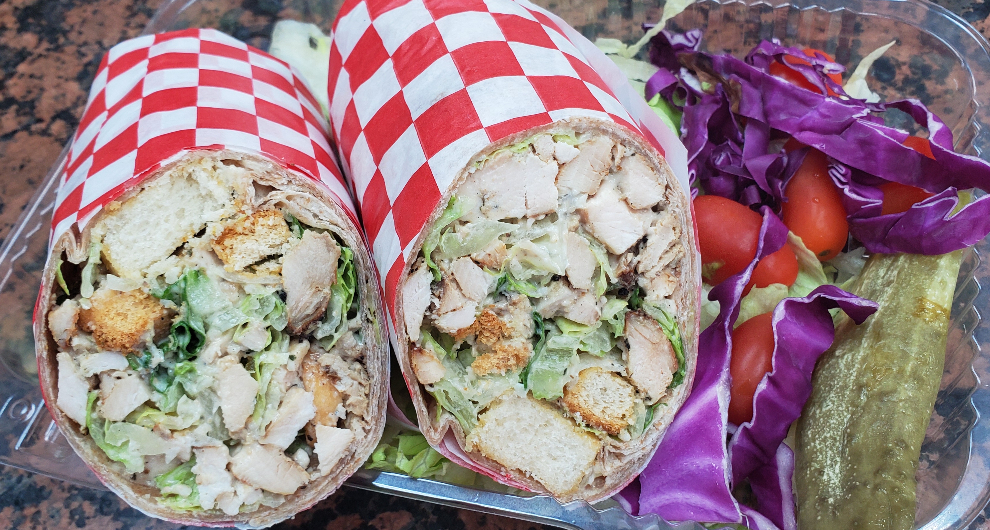 Order  Chicken Caesar Wrap (grilled chicken breast romaine lettuce tomatoes Caesar Dressing parmesan cheese & croutons wrap) food online from American Gourmet Foods Deli store, New York on bringmethat.com
