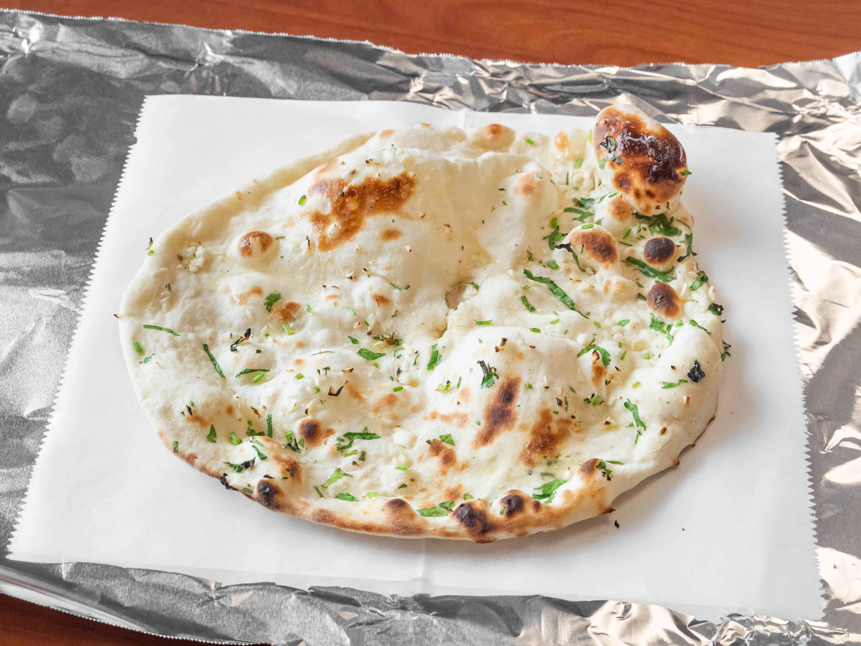 Order 79. Naan food online from Madina Indian Restaurant store, St. Clair Shores on bringmethat.com