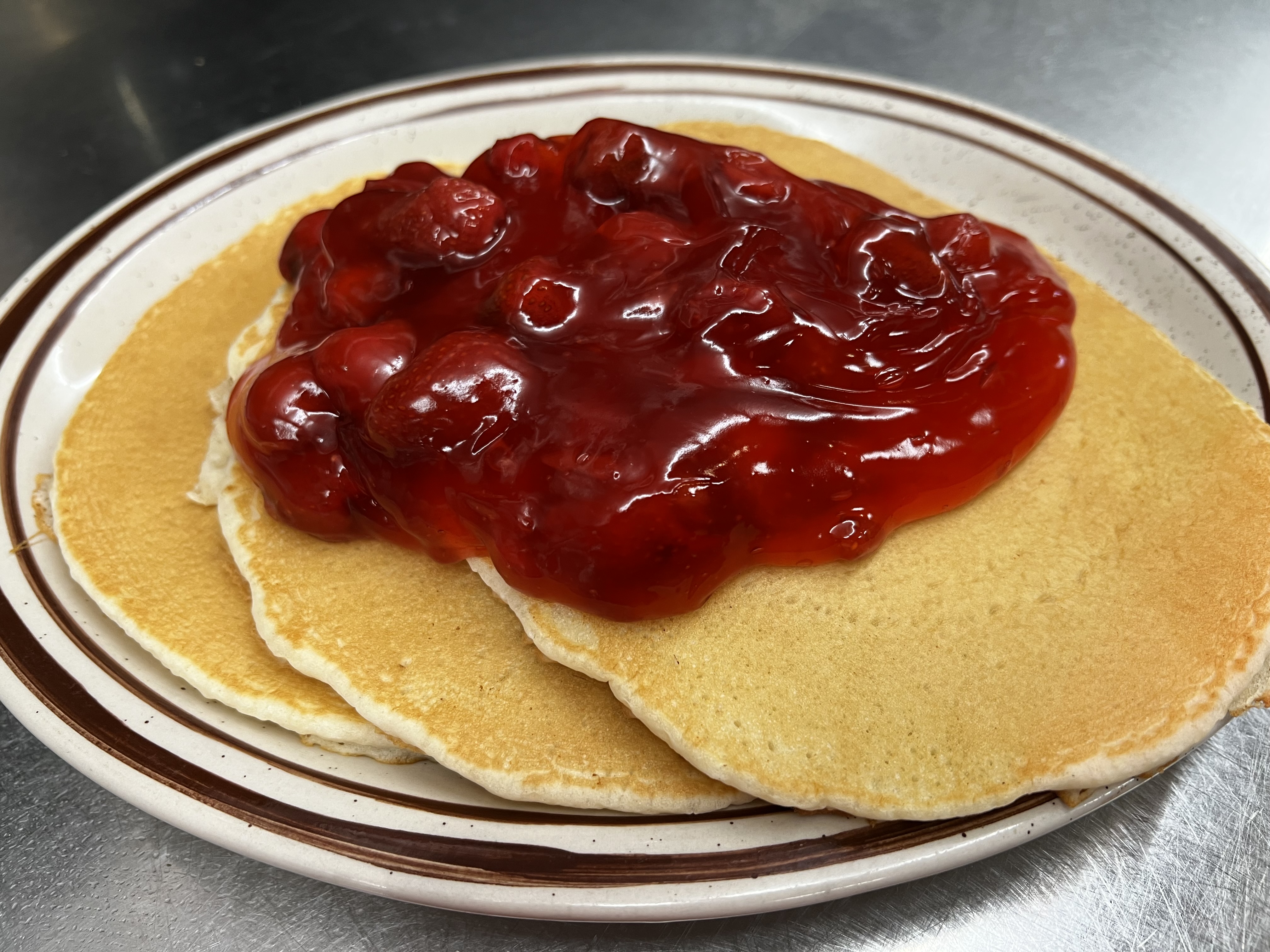 Order Strawberry Topped Pancakes food online from Eastridge Family Restaurant store, Rochester on bringmethat.com