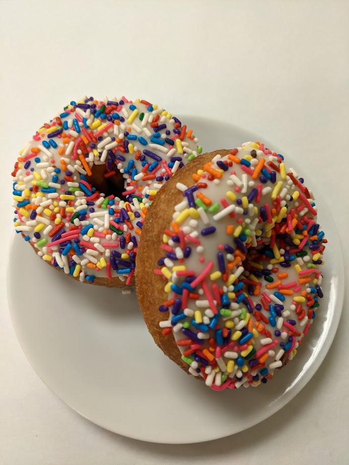 Order Yellow Cake Donut with Chocolate Frosting and Sprinkles food online from Morkes Chocolate store, Huntley on bringmethat.com