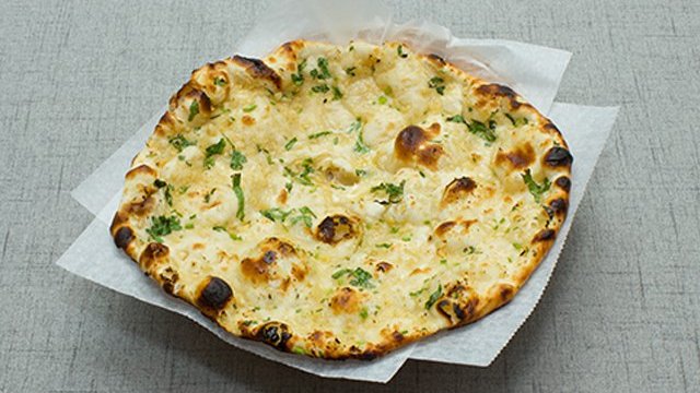 Order Garlic Naan food online from Sathi Indian Restaurant store, New York on bringmethat.com