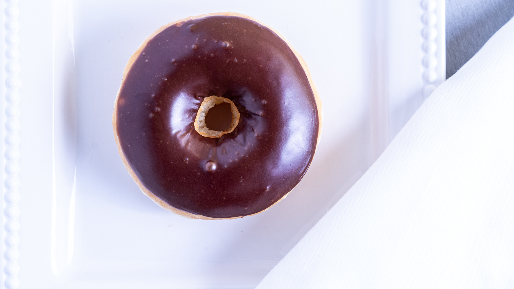 Order Chocolate Donut food online from Bakers Dozen Donuts store, Sachse on bringmethat.com