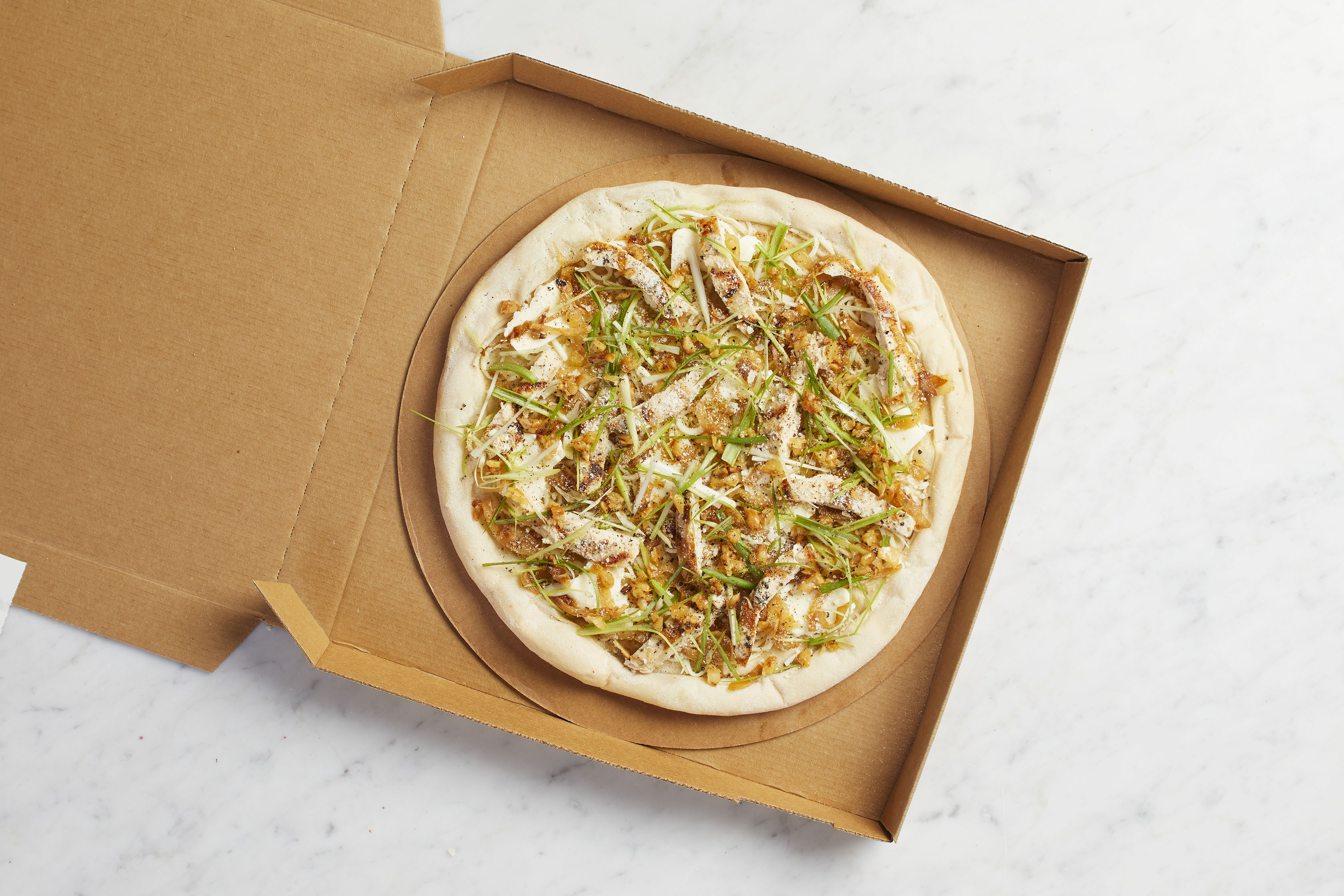 Order Take and Bake Roasted Garlic Chicken Pizza  food online from California Pizza Kitchen - River City Dr store, Jacksonville on bringmethat.com