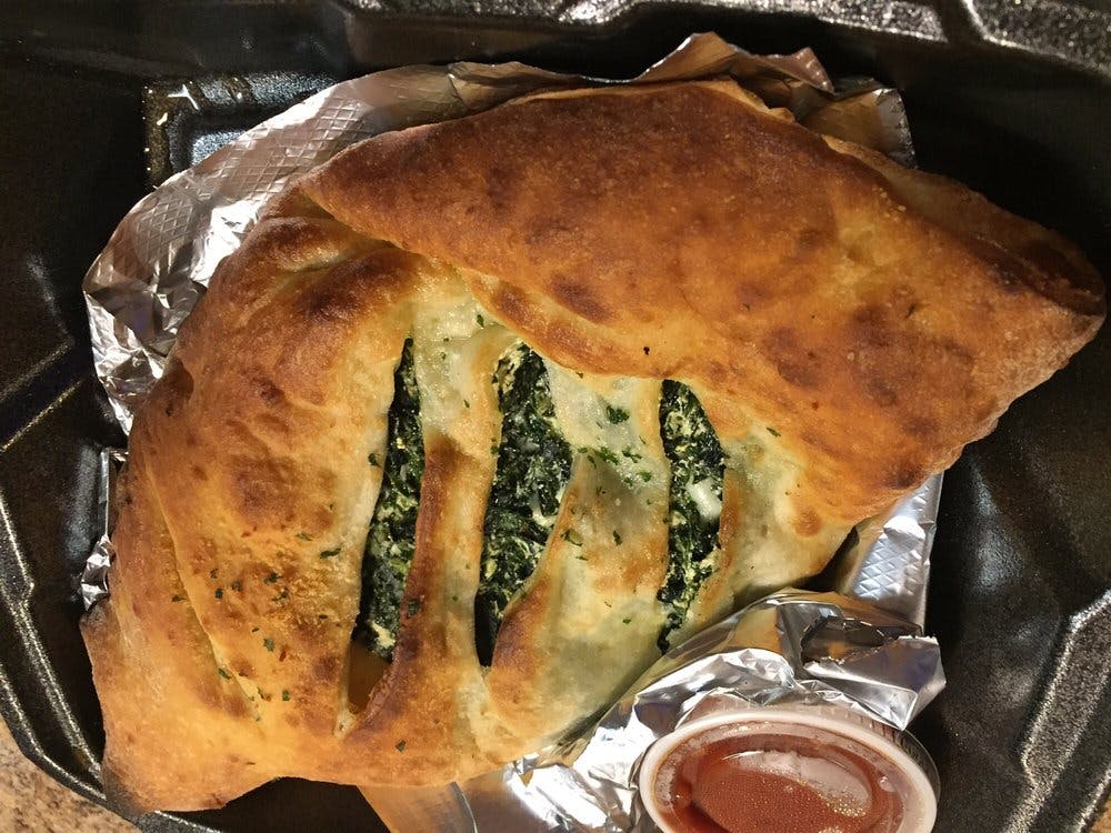 Order Spinach Calzone - Roll food online from Milano's Pizza store, Collierville on bringmethat.com