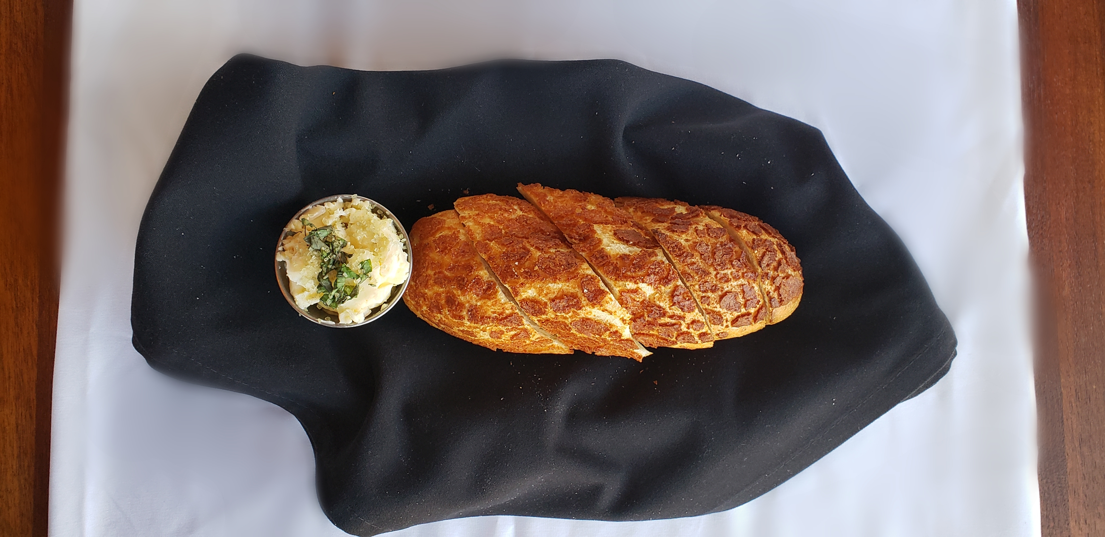 Order Warm Breadbasket with Salted Basil Butter food online from Colorado Flatbread Company store, Golden on bringmethat.com