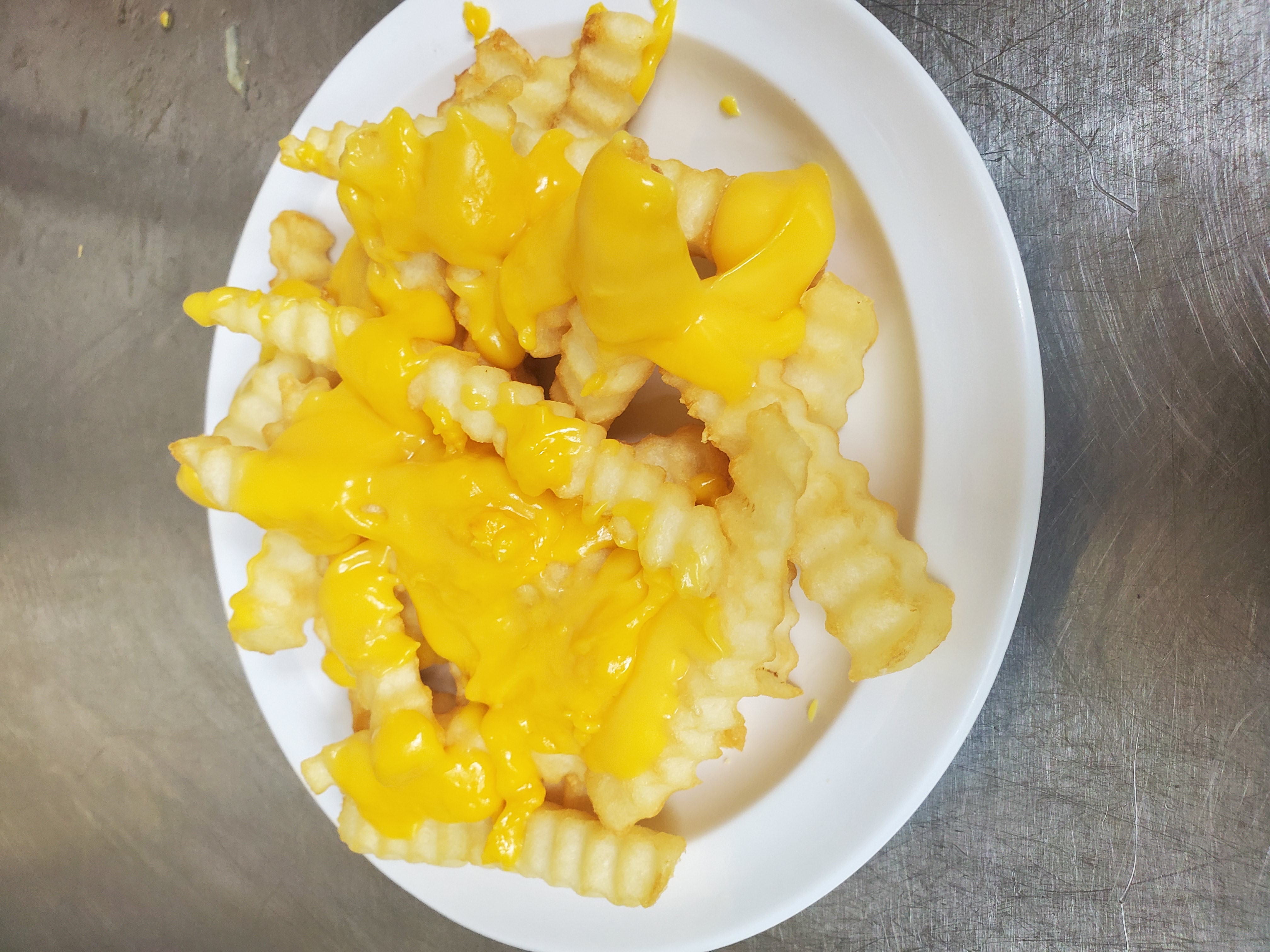 Order French fries (melted cheese) food online from Aminas Cafe store, Bronx on bringmethat.com