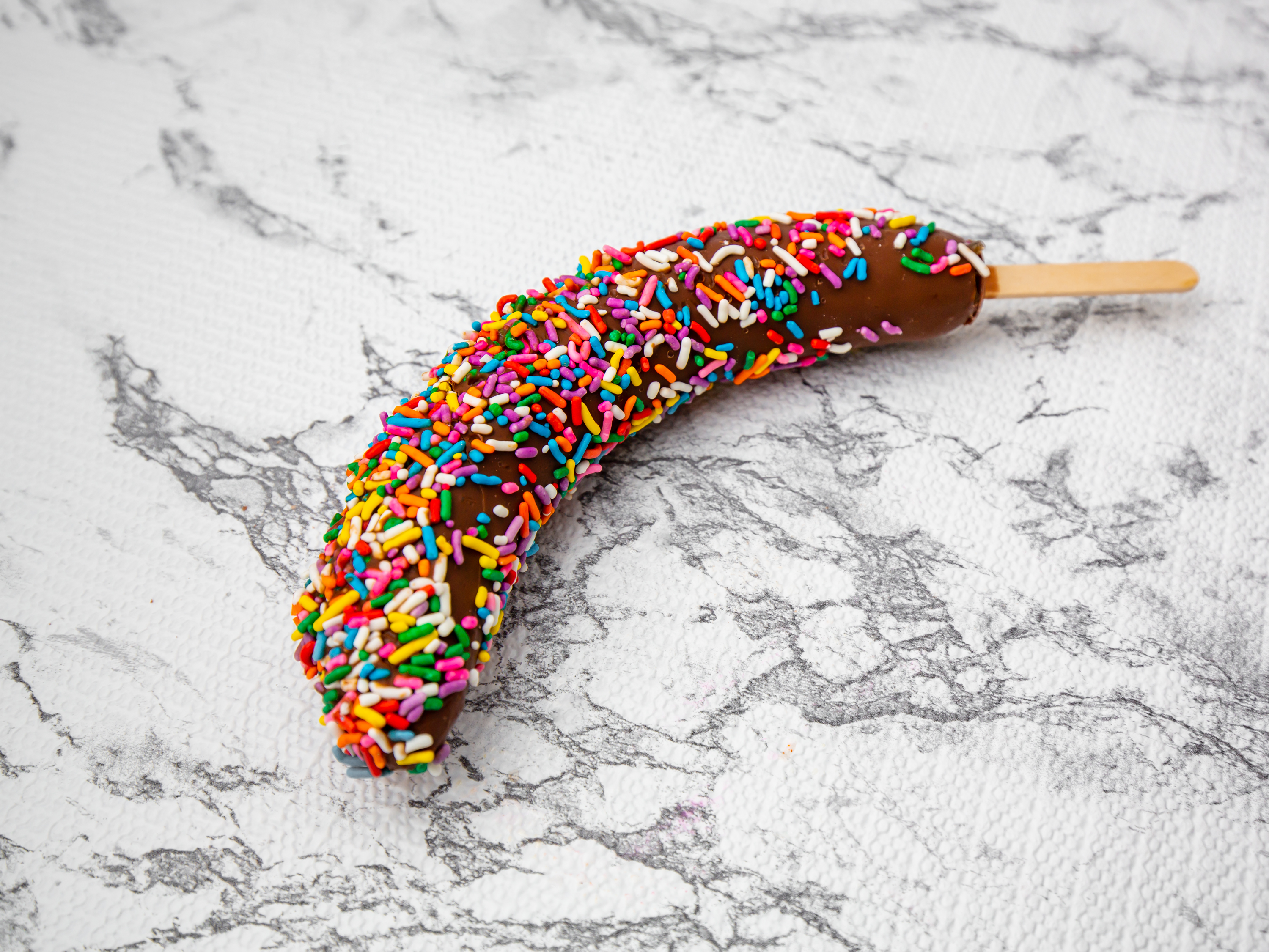 Order Chocolate Dipped Frozen Banana - Sprinkles  food online from Ome Calli store, Beaverton on bringmethat.com