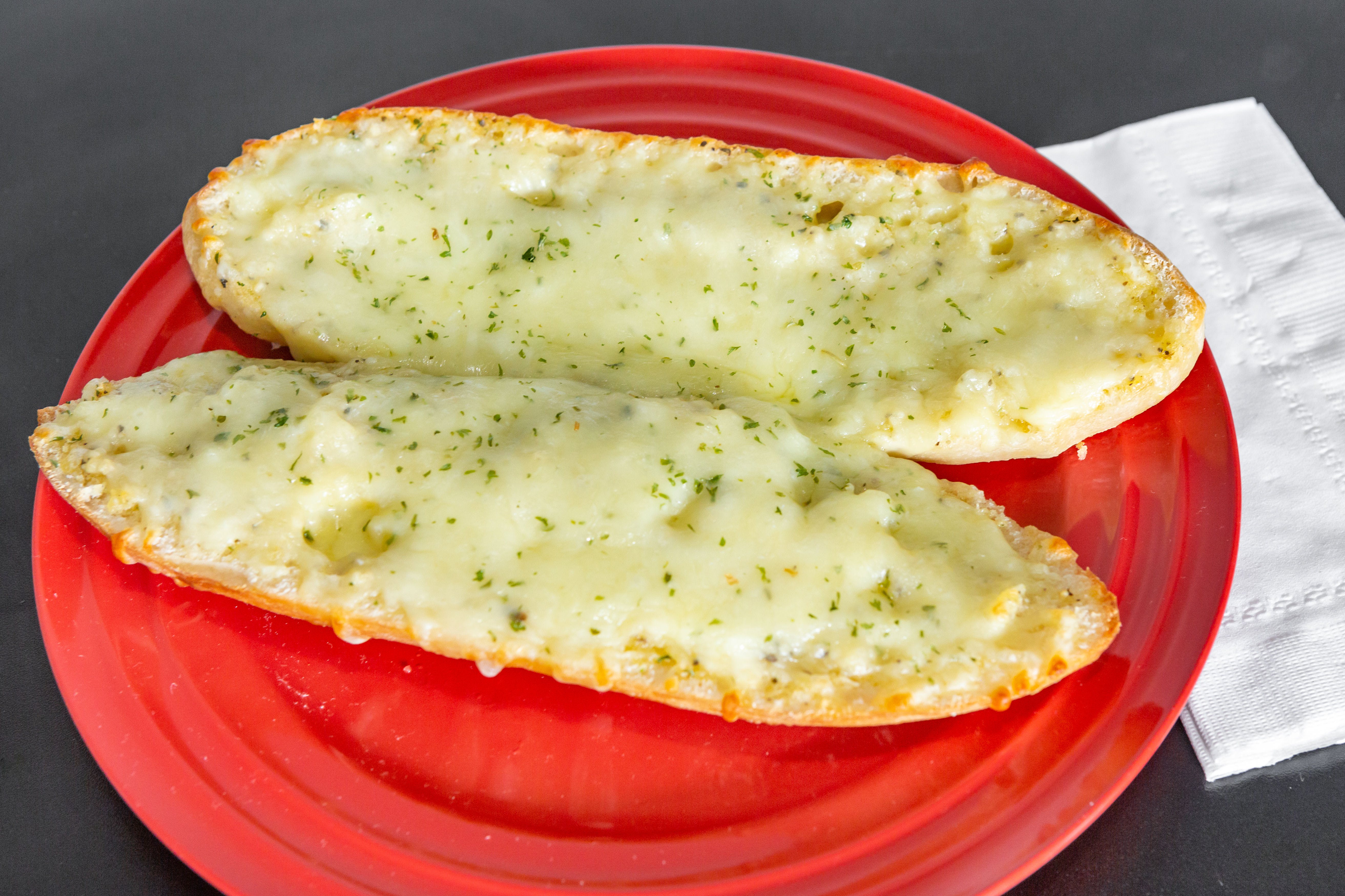 Order Garlic Bread with Cheese - Appetizer food online from Tangy Tomato store, Syracuse on bringmethat.com