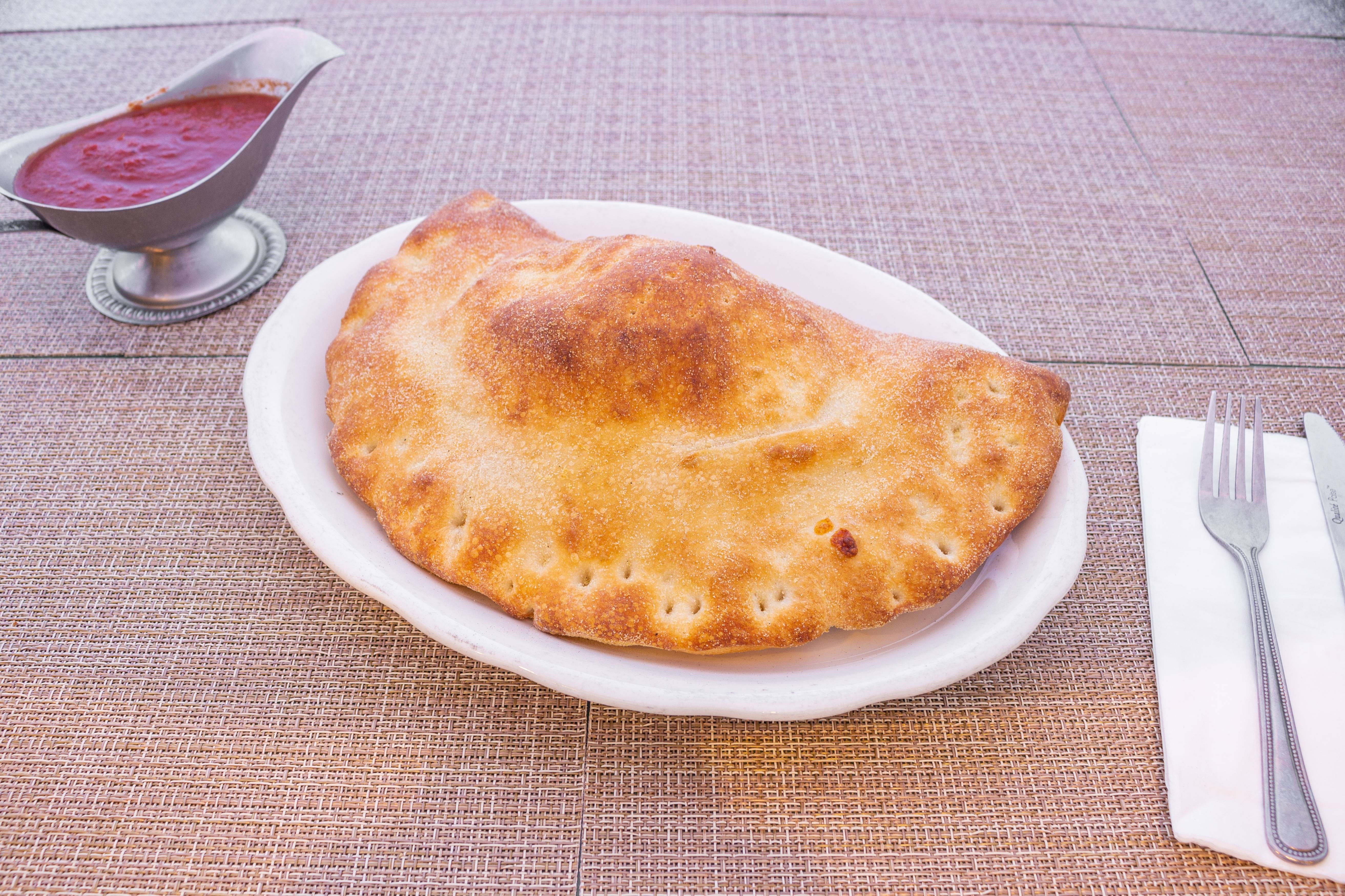 Order Calzone - Calzone food online from Pizza Man Trattoria Italiano store, Pompton Plains on bringmethat.com