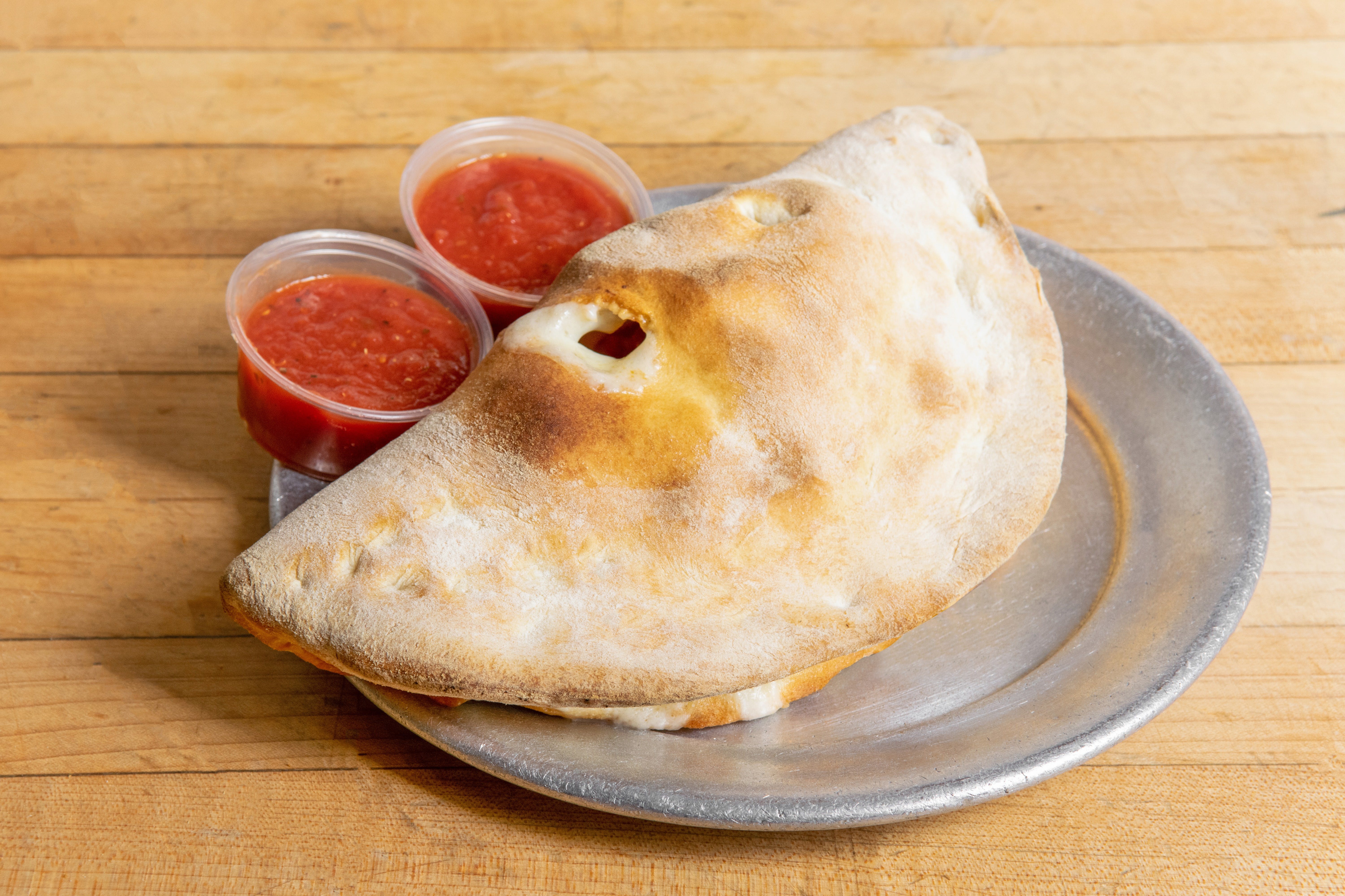 Order Calzone - Calzone food online from Amico Pizza store, Rochester on bringmethat.com