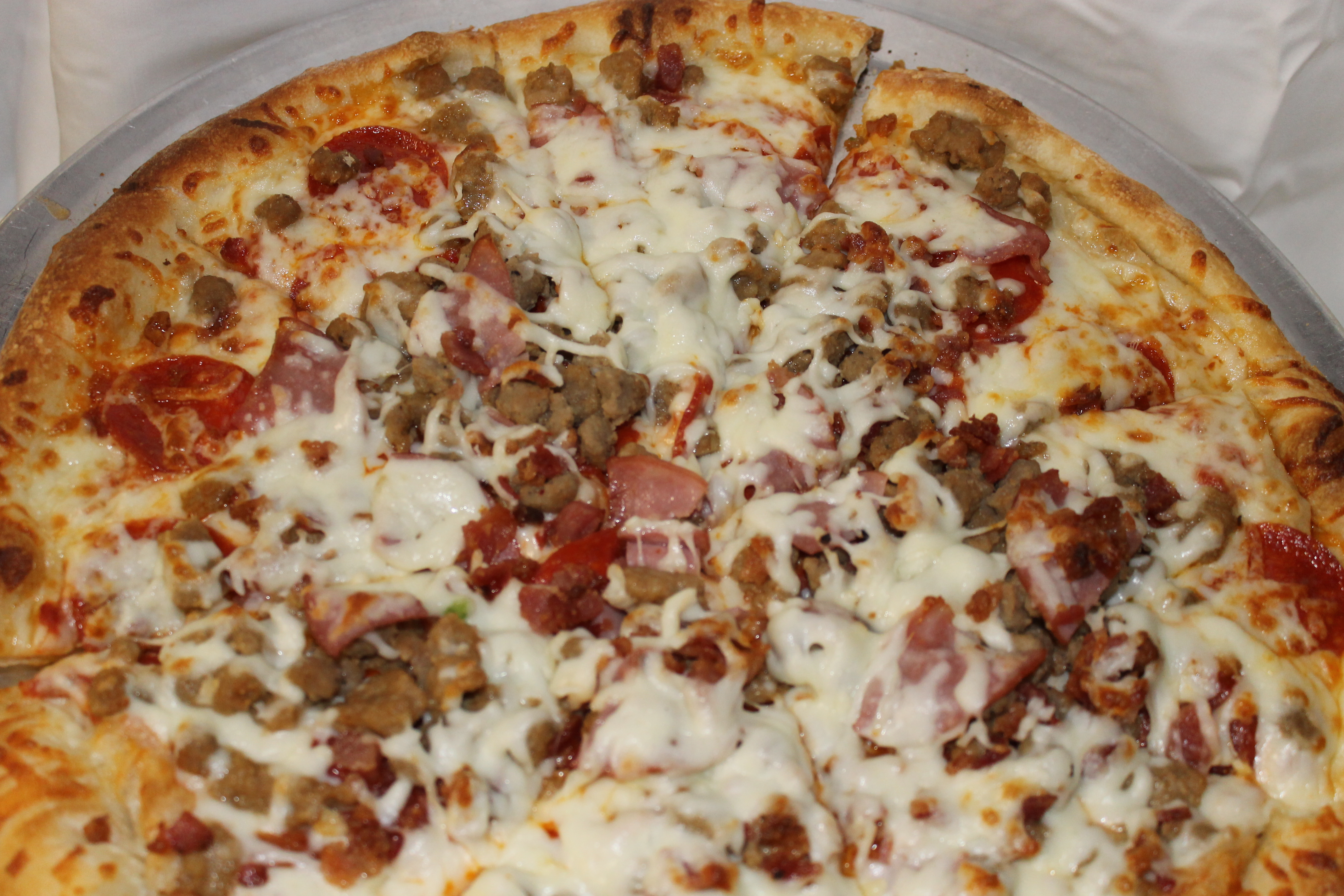 Order Meat Lovers Pizza food online from Luigis Pizza store, Gatlinburg on bringmethat.com
