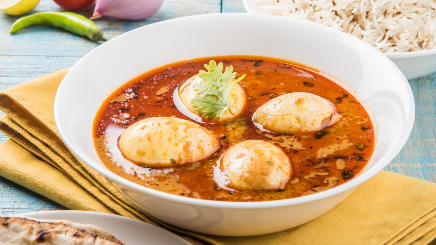 Order Classic Spicy Egg Curry food online from Tikka Cravings store, Buffalo on bringmethat.com