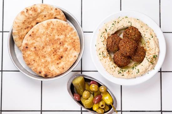 Order Hummus Falafel food online from 12 chairs store, New York on bringmethat.com