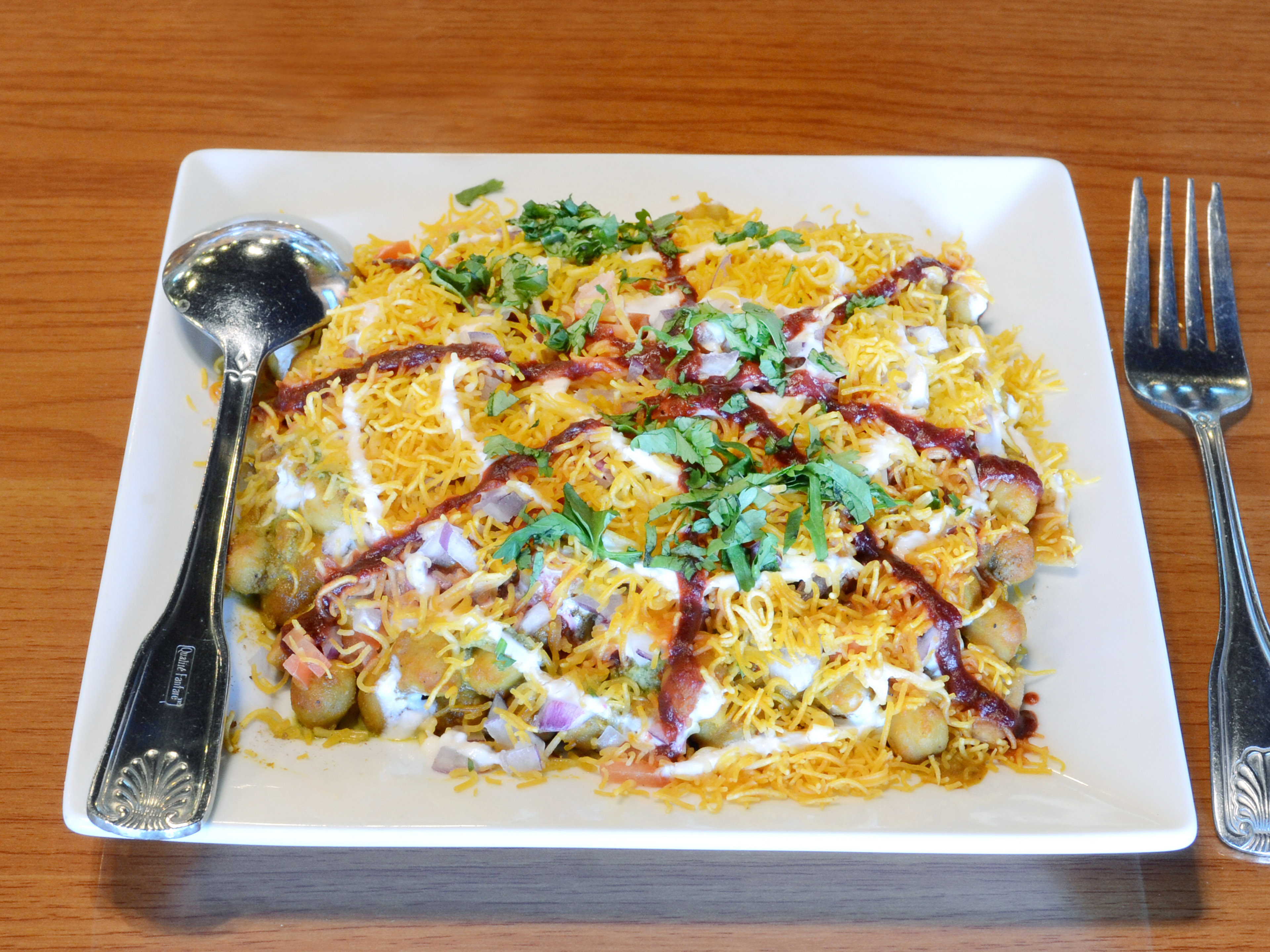 Order Samosa Chaat food online from Rivaj Indian Cuisine store, Buffalo Grove on bringmethat.com