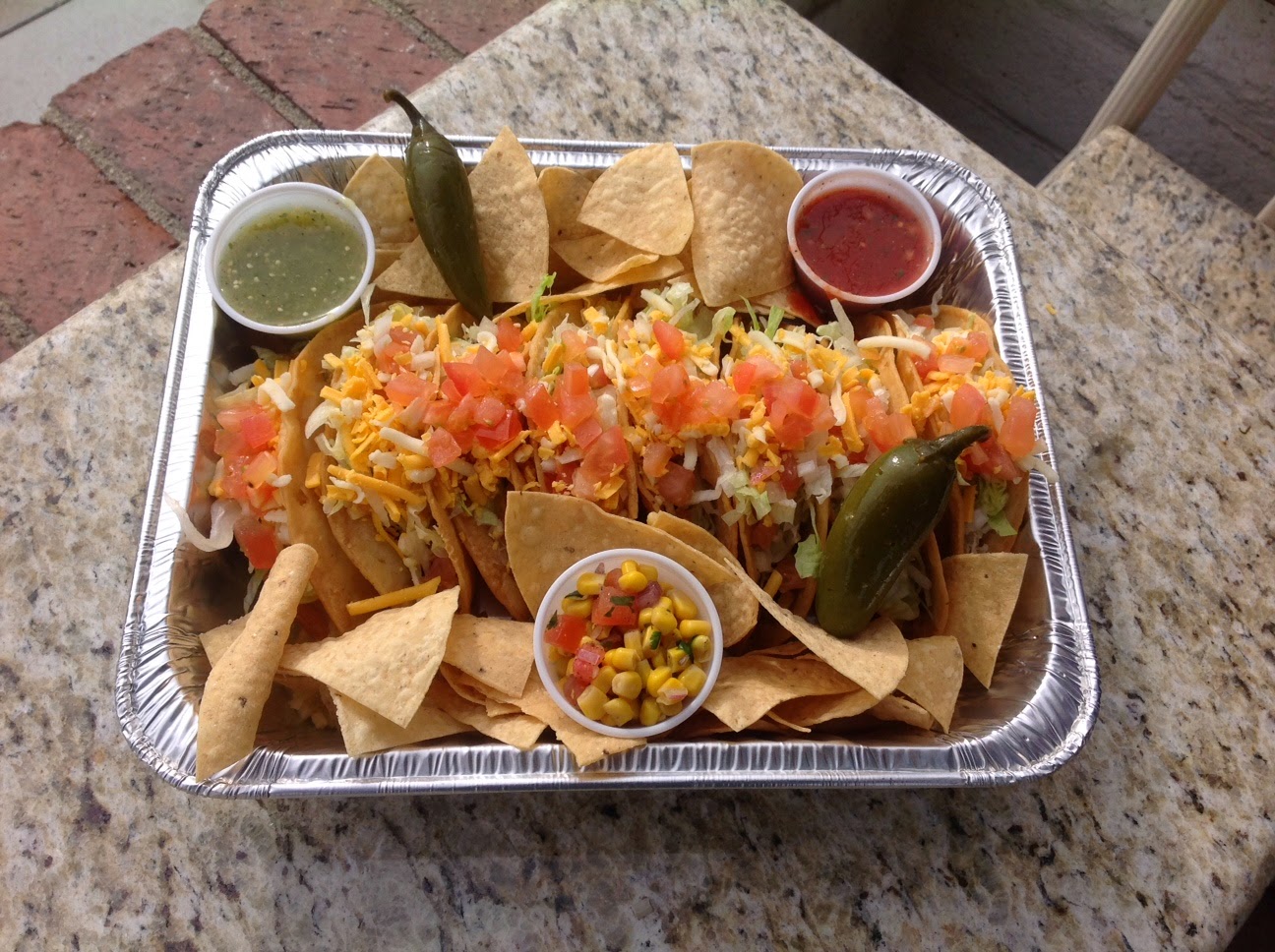 Order 8 Tacos Family Pack, 1 Cheese Quesadilla, 20 oz Rice, 20 oz Beans, 8 oz. salsa food online from Tacos And Wings store, Sunland on bringmethat.com