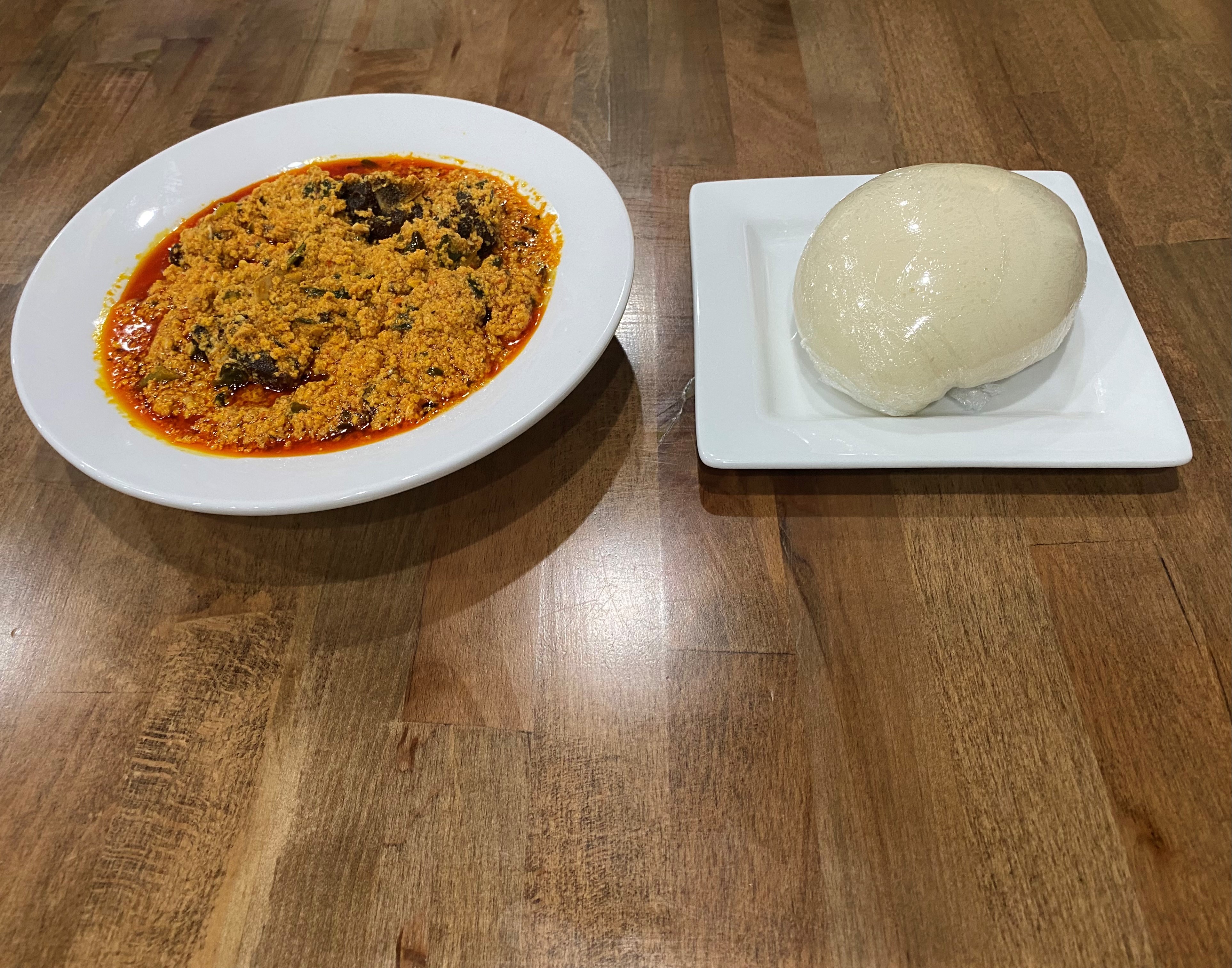 Order Poundo-Fufu + Egusi Soup + Goat Meat food online from Fusion Vibes Kitchen + Bar store, Richardson on bringmethat.com