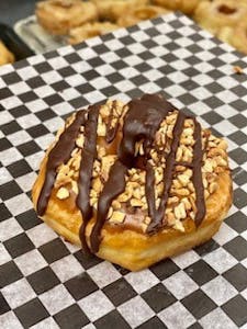 Order Snickers Donut food online from Bearscat Bakery store, Mesa on bringmethat.com