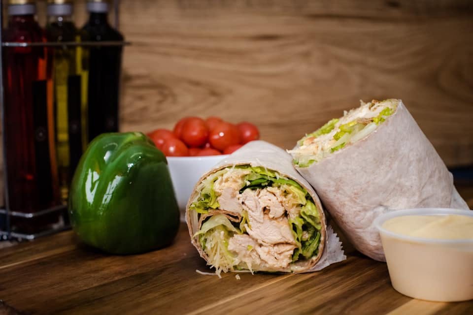 Order Grilled Chicken Caesar Wrap - Wraps Sandwiches food online from Uncle Joe's Pizza & Restaurant store, Warminster on bringmethat.com