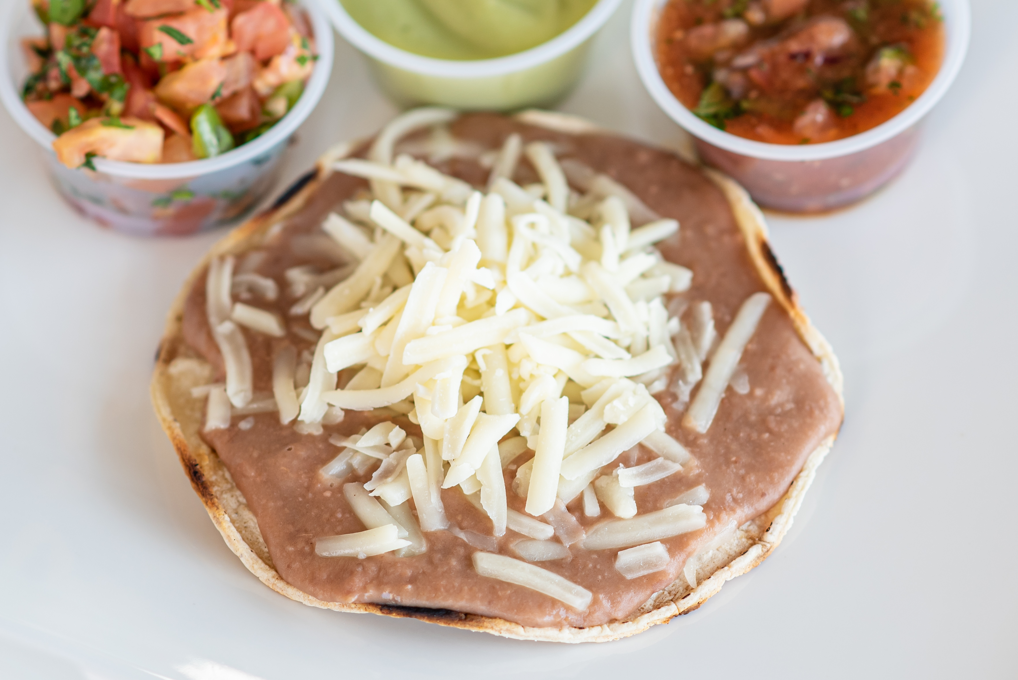 Order Bean and Cheese Tostada food online from Backyard Taco store, Mesa on bringmethat.com