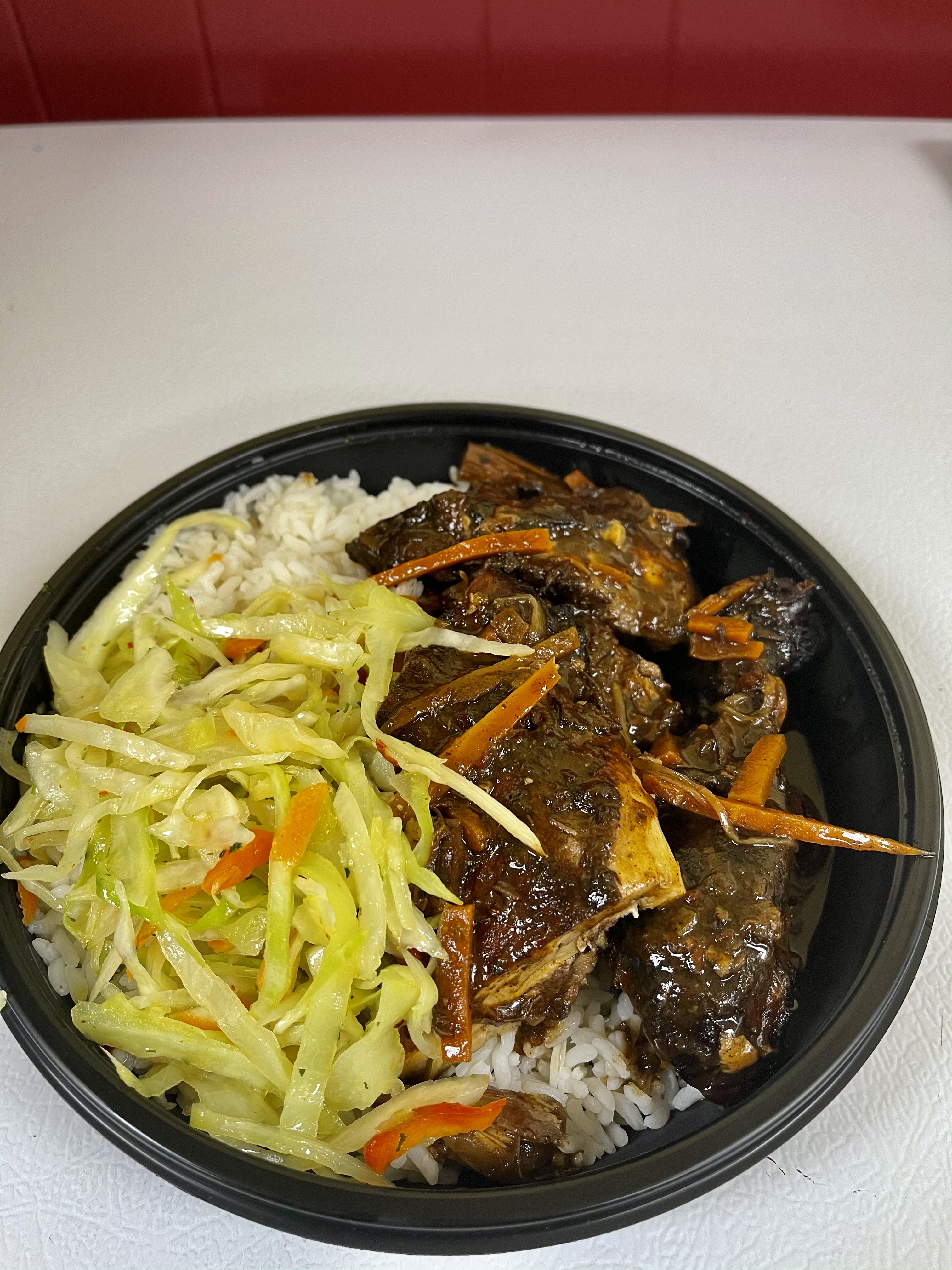 Order Jerk Chicken leg quarter with Veggie Rice food online from Taste of the Caribbean store, Capitol Heights on bringmethat.com