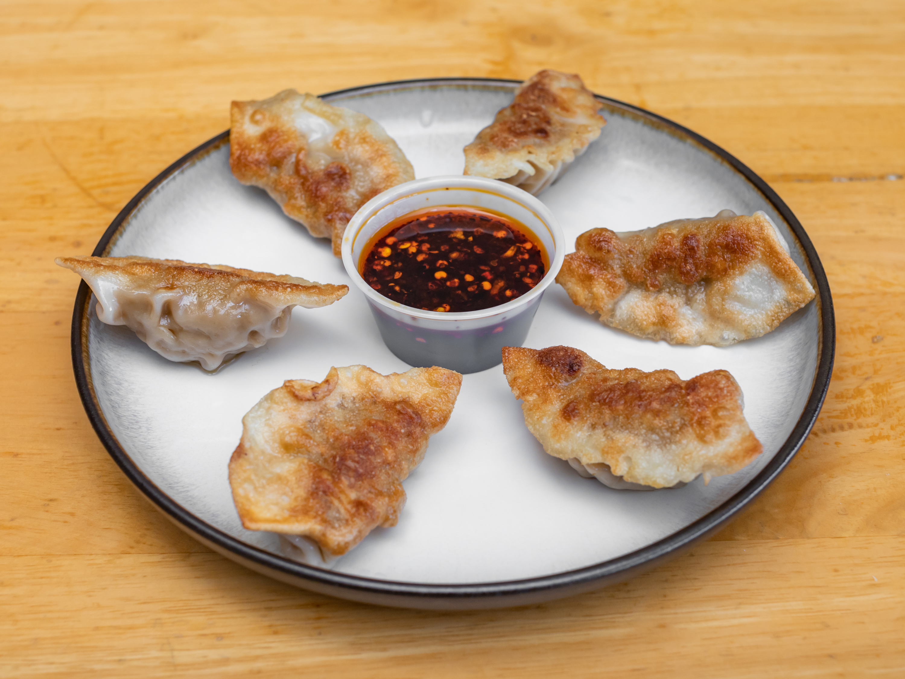 Order A5. Pan Fried Pork Dumpling food online from Rice King Chinese Restaurant store, Toledo on bringmethat.com