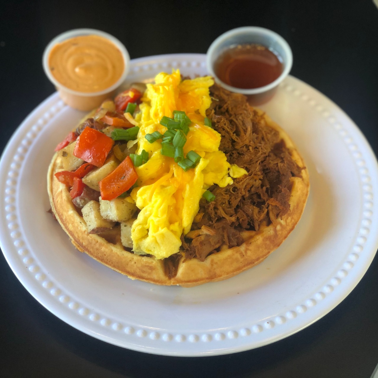 Order Loaded Pulled Pork Waffle:pulled pork, 2 scrambled eggs, green onions, cheddar cheese, home fries, and chipotle remoulade. food online from Crepe Express store, Houston on bringmethat.com