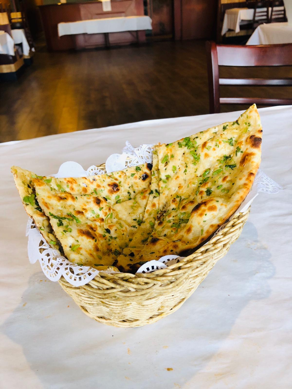 Order Garlic Naan food online from Rajmahal Indian Restaurant store, Olathe on bringmethat.com
