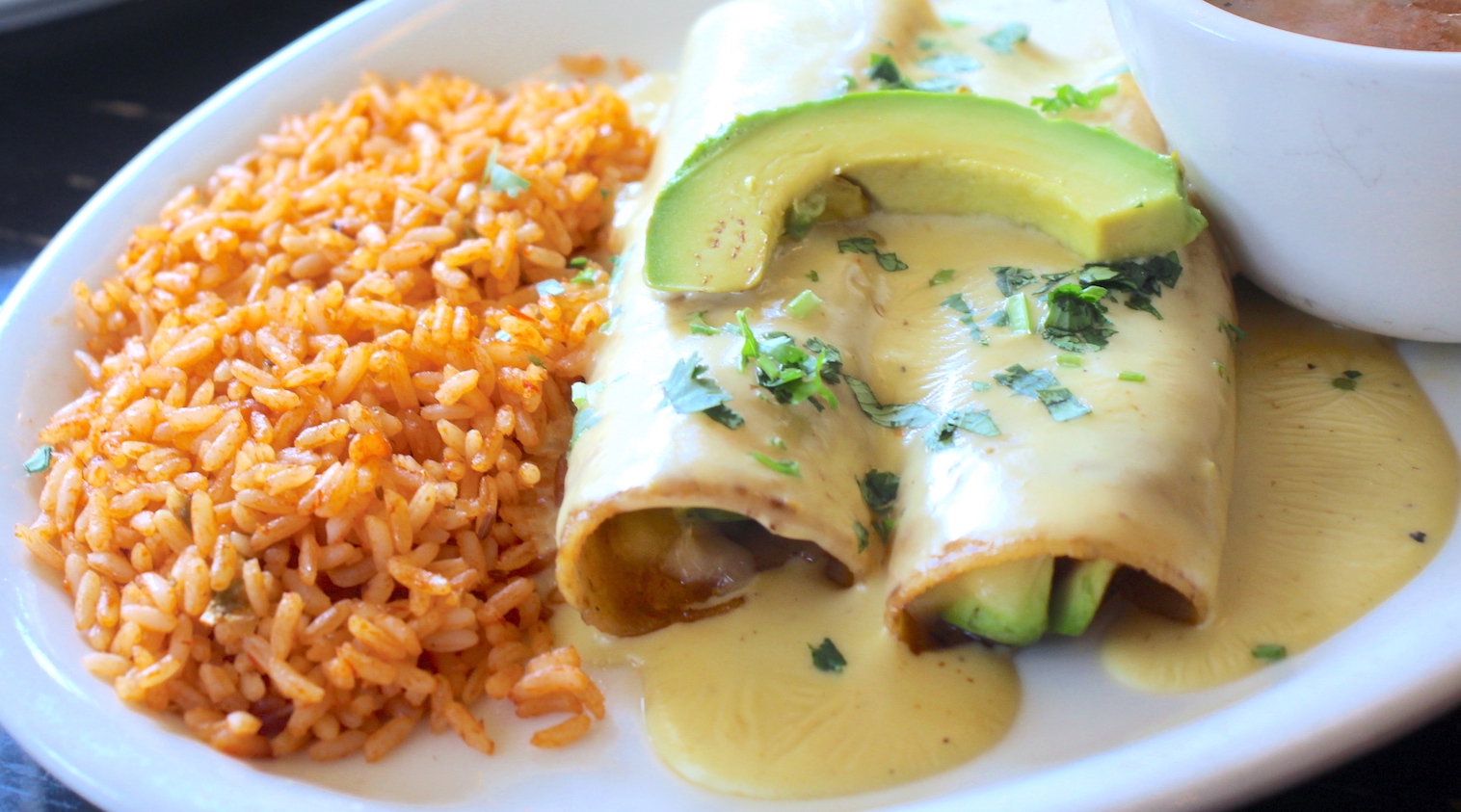 Order Avocado Enchilada food online from Alamo Cafe store, San Antonio on bringmethat.com