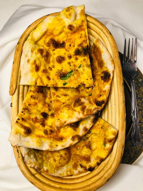 Order Garlic Naan food online from New Delhi Restaurant store, San Francisco on bringmethat.com