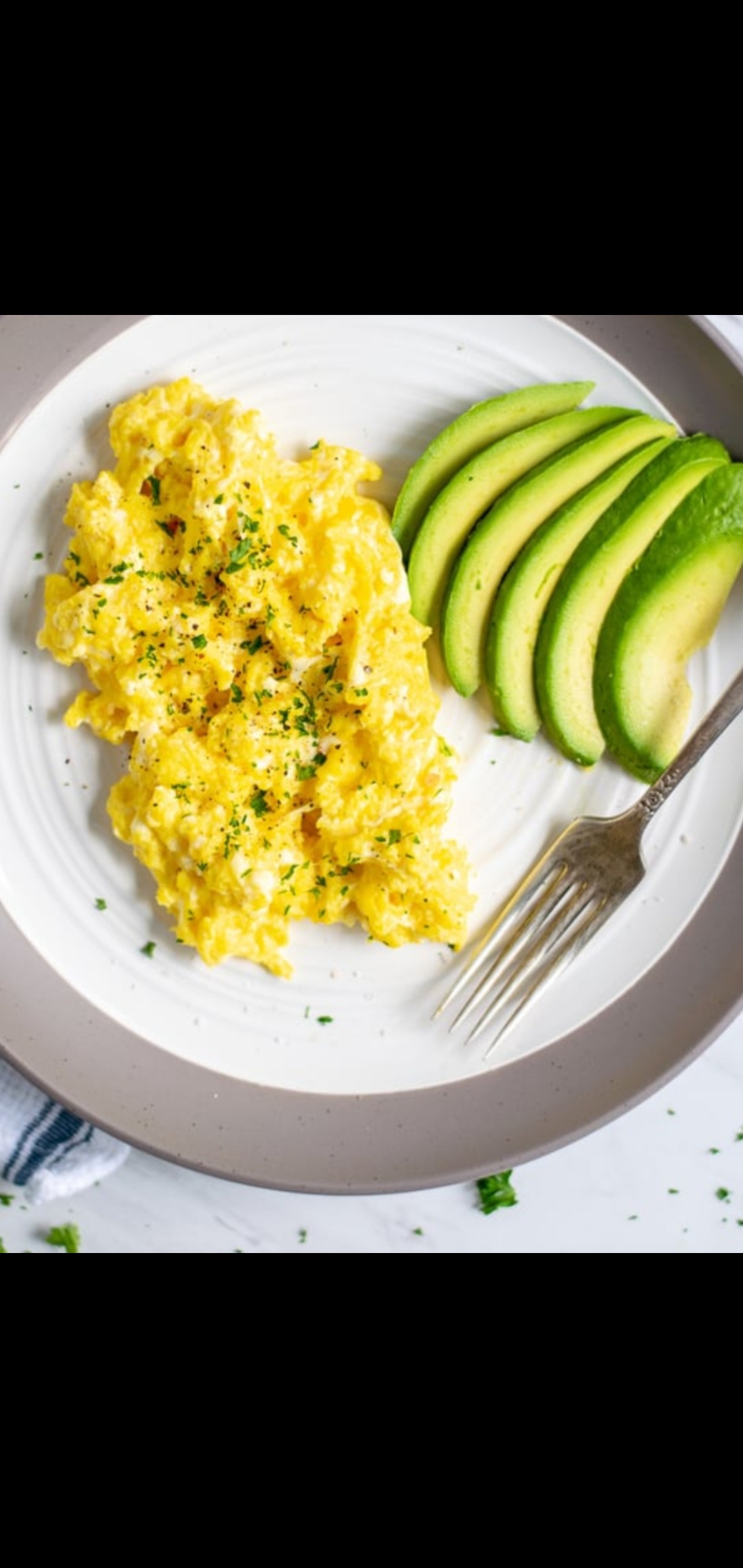 Order Scrambled Eggs With Half Avocado On A Plate & Side Toast  food online from American Gourmet Foods Deli store, New York on bringmethat.com