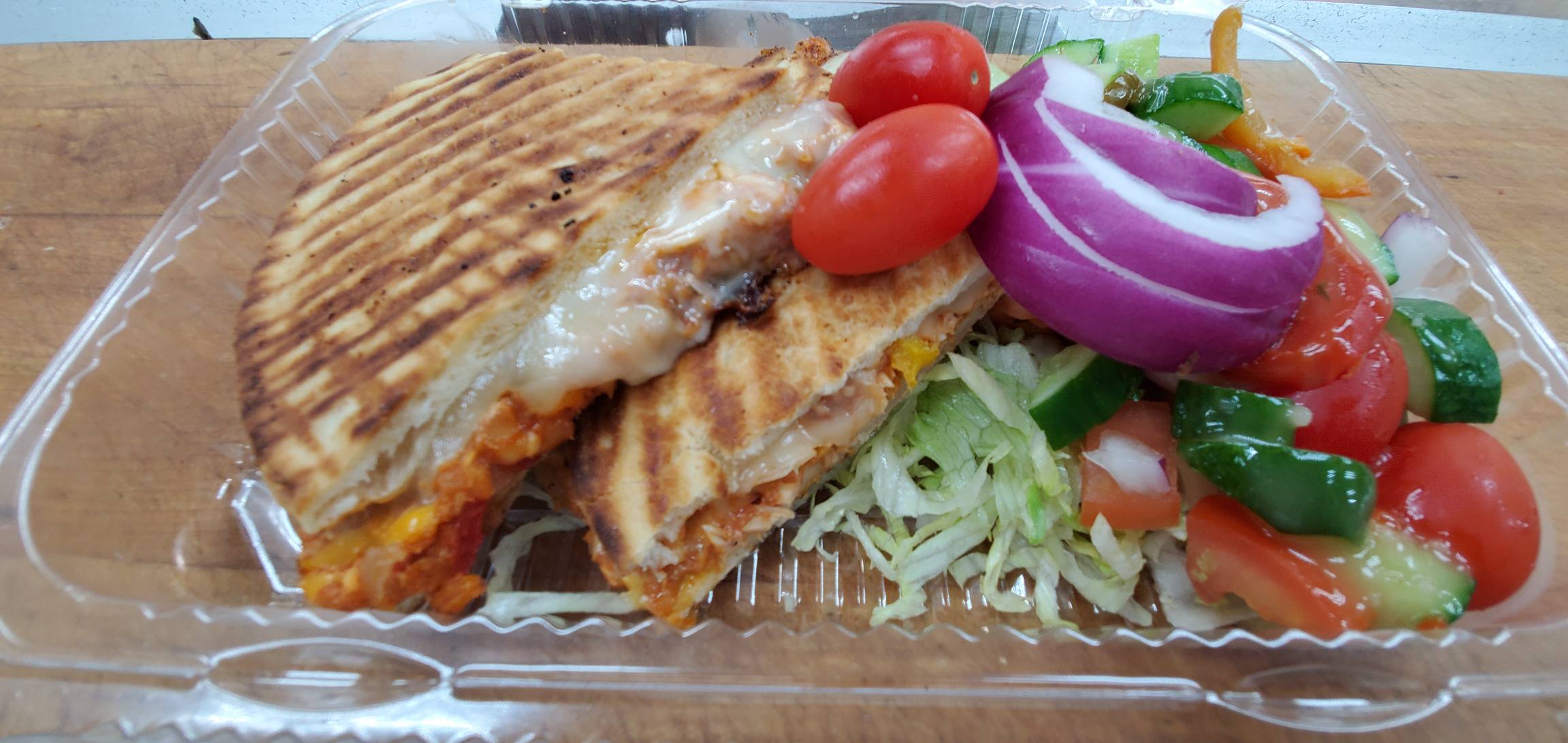 Order Chicken Fajita Panini (grilled chicken Vermont cheddar roasted peppers caramelized onions & salsa) food online from American Gourmet Foods Deli store, New York on bringmethat.com