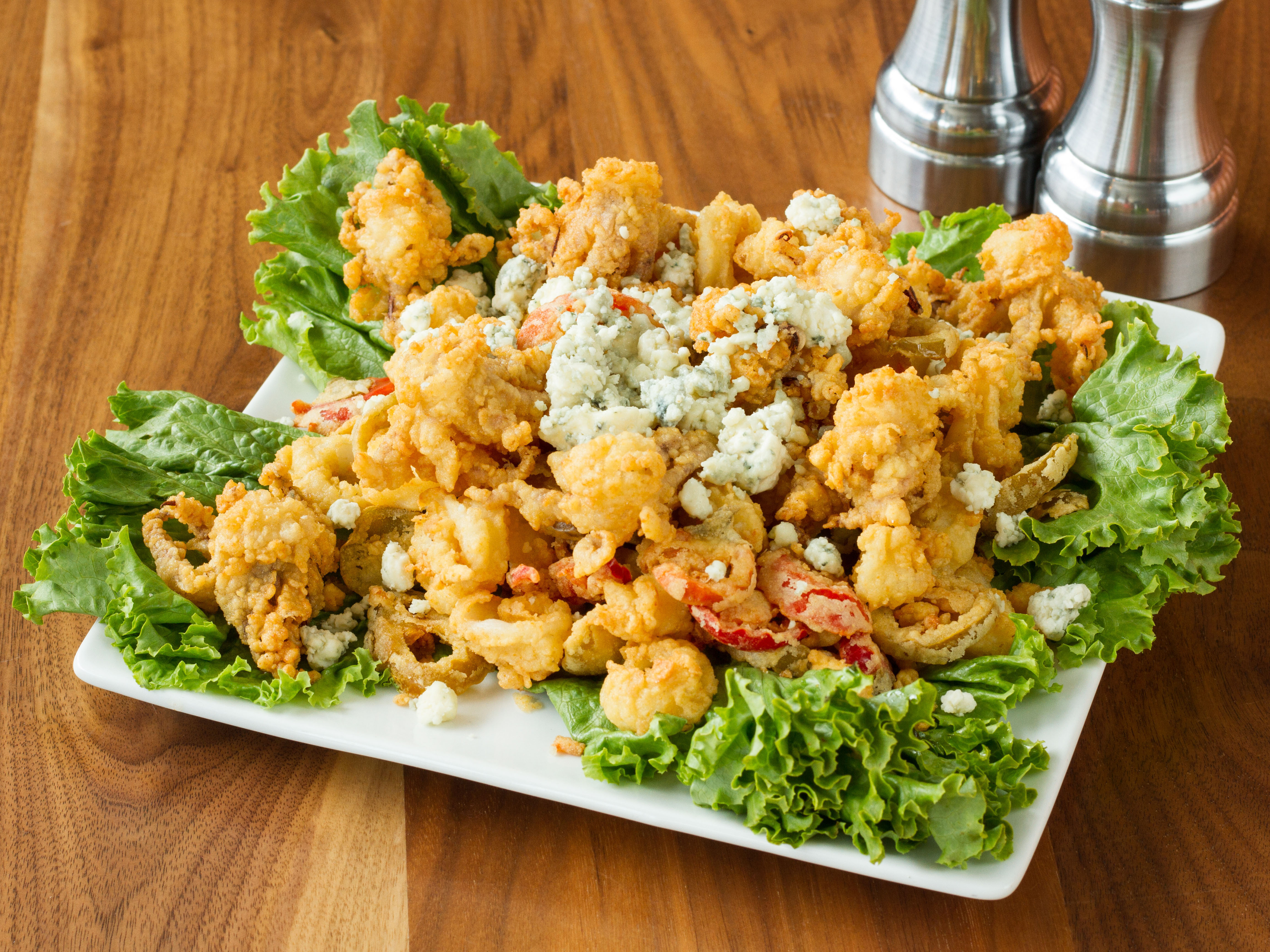 Order Fried Calamari food online from Maggie McFly's Restaurant store, Middlebury on bringmethat.com