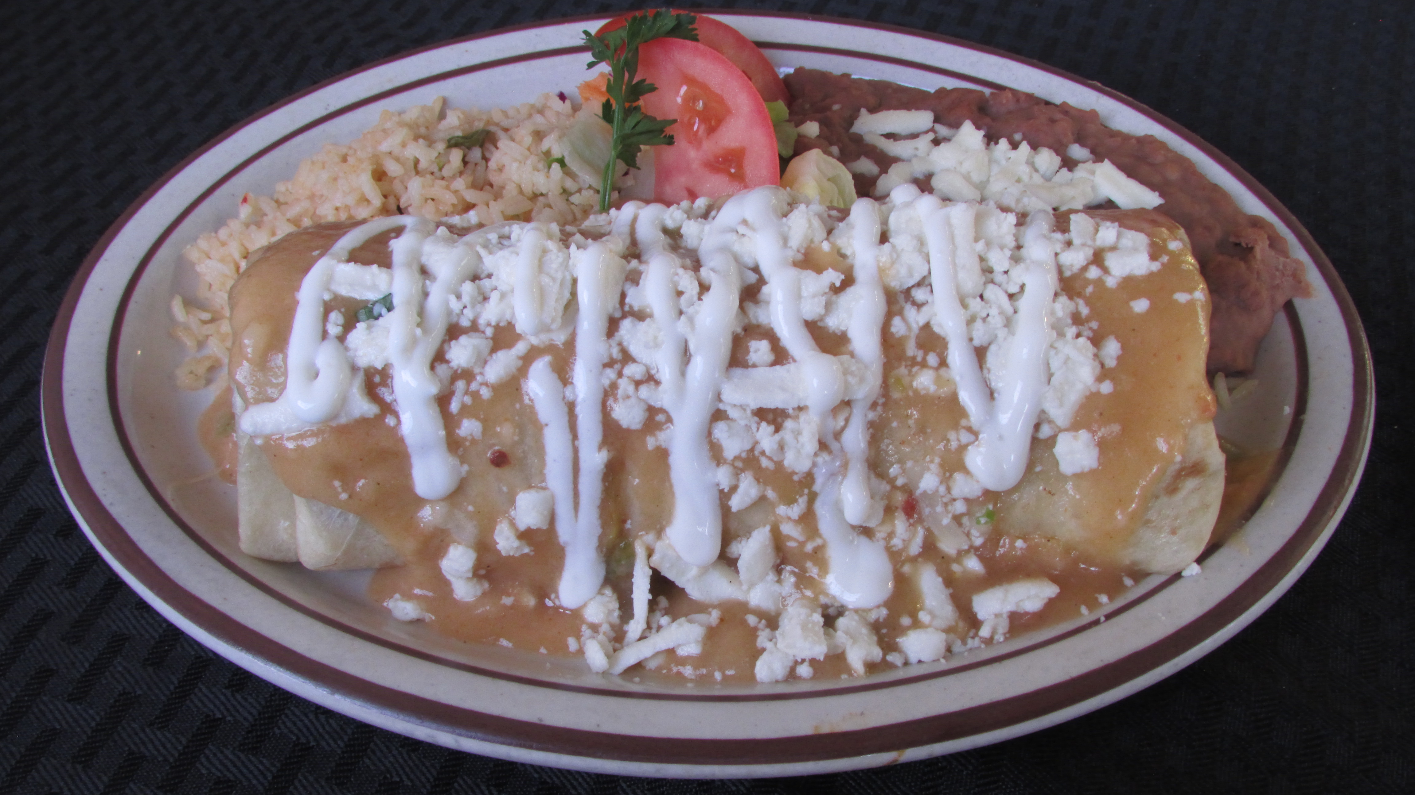 Order Chicken Burrito Ranchero food online from Tortillas Restaurant store, Cathedral City on bringmethat.com