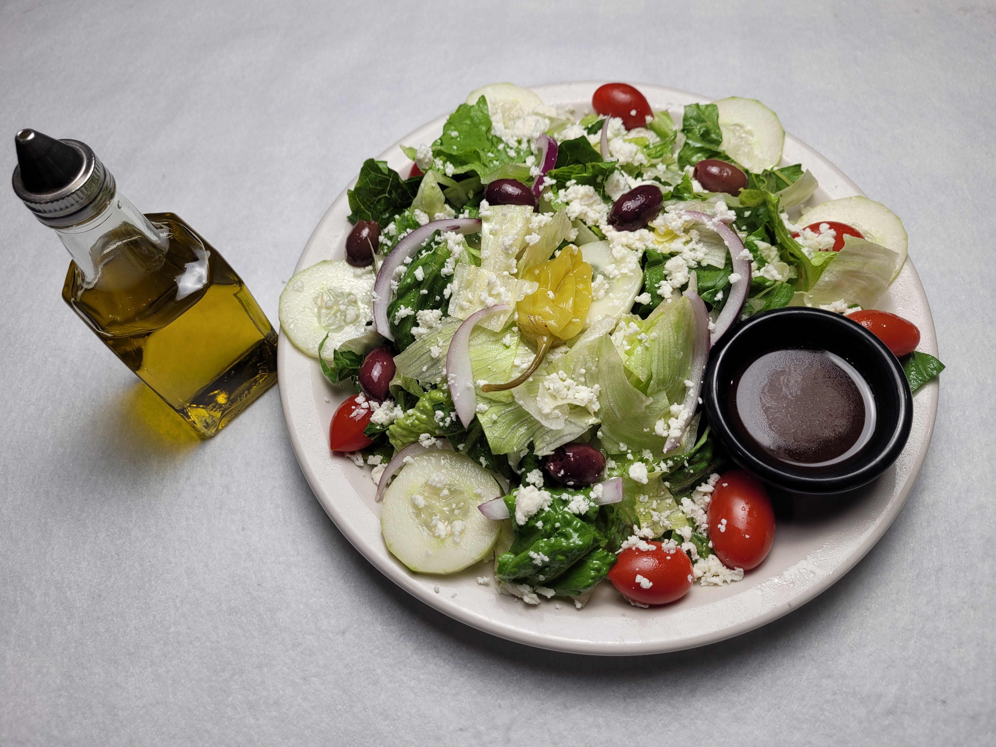 Order Greek Salad - Medium food online from Mony Pizzeria store, Houston on bringmethat.com