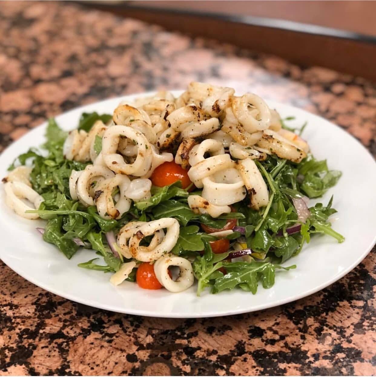 Order Grilled Calamari Salad - Salad food online from Gino's Pizzeria store, Staten Island on bringmethat.com