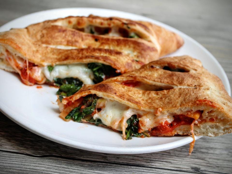 Order Garlic Spinach Calzone - Calzone food online from Domani Pizzeria store, Seattle on bringmethat.com