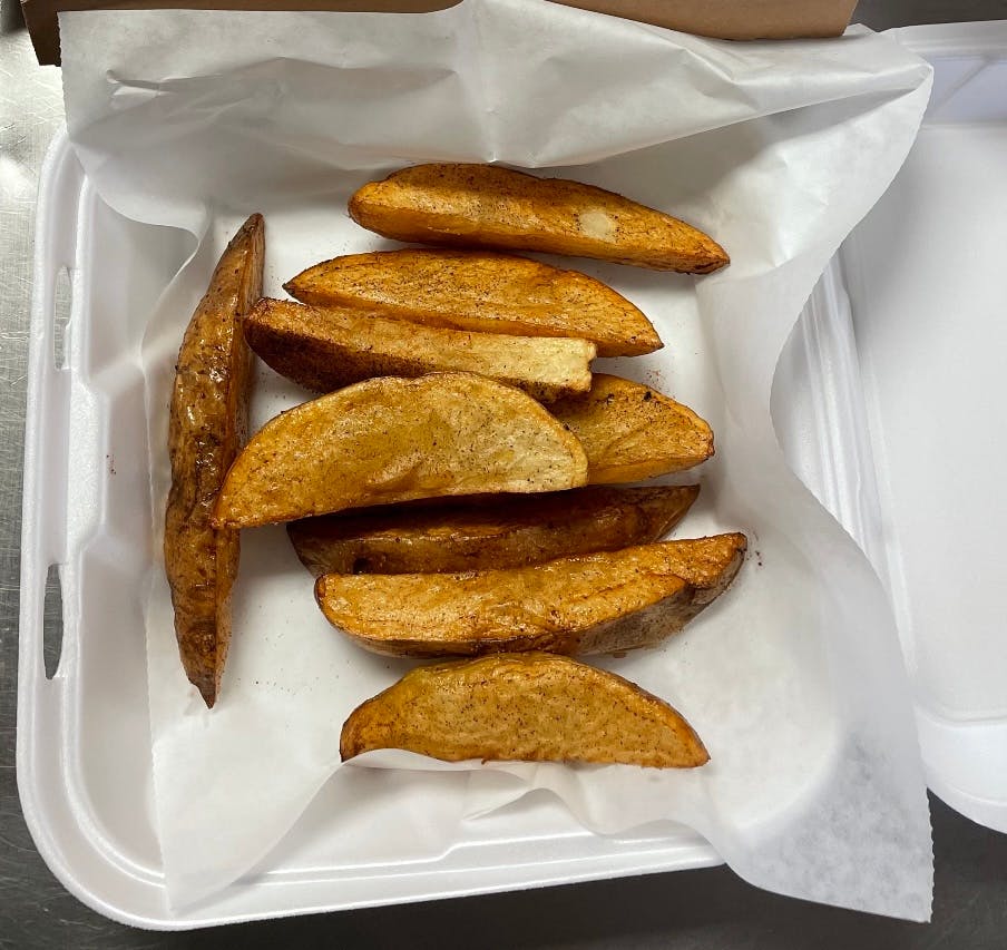 Order Potato Wedges - 8 Pieces food online from Pizza Man store, Ellsworth on bringmethat.com