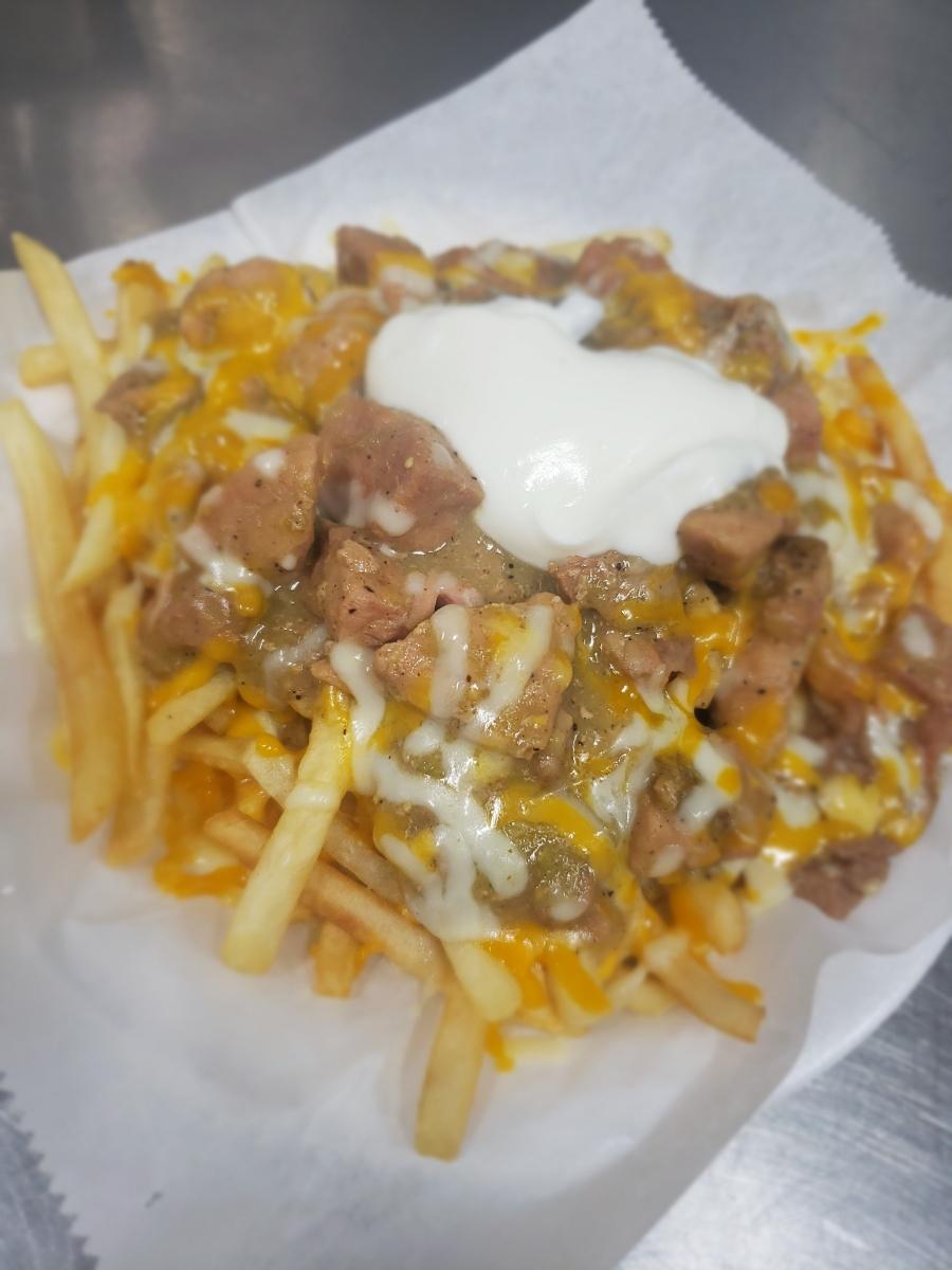Order French Fries Topped with Homemade Pork Chili Verde food online from Tacos And Wings store, Sunland on bringmethat.com