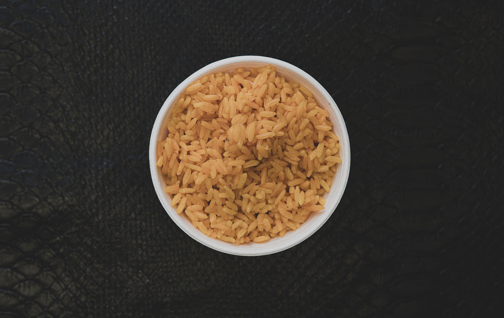 Order yellow rice food online from Yard Cooked Dishes store, Charlotte on bringmethat.com