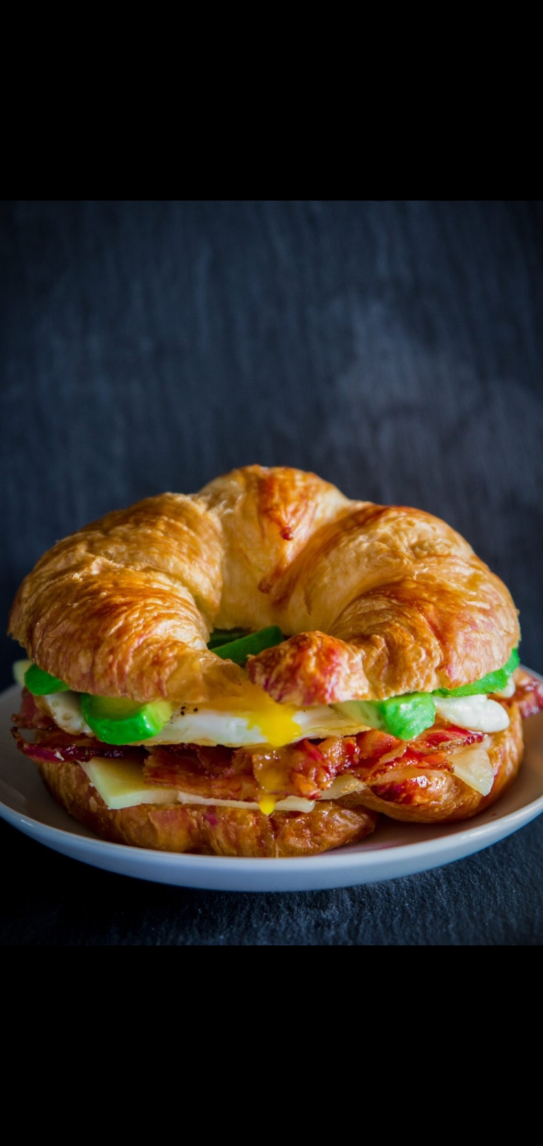 Order Three Egg Whites Turkey Bacon Avocado And Cheese Croissant  food online from American Gourmet Foods Deli store, New York on bringmethat.com
