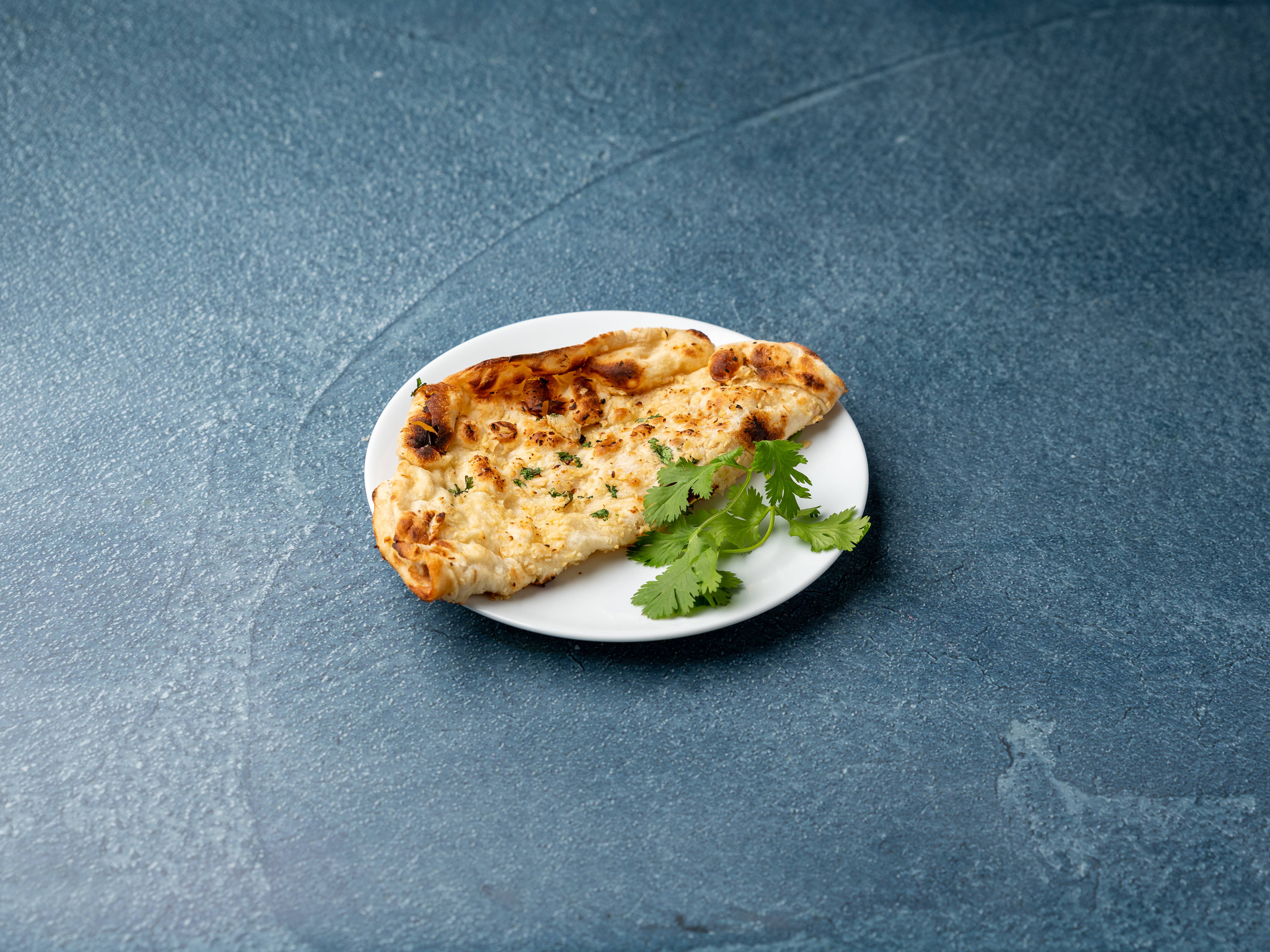 Order Garlic Naan food online from Tiffin store, Cherry Hill on bringmethat.com