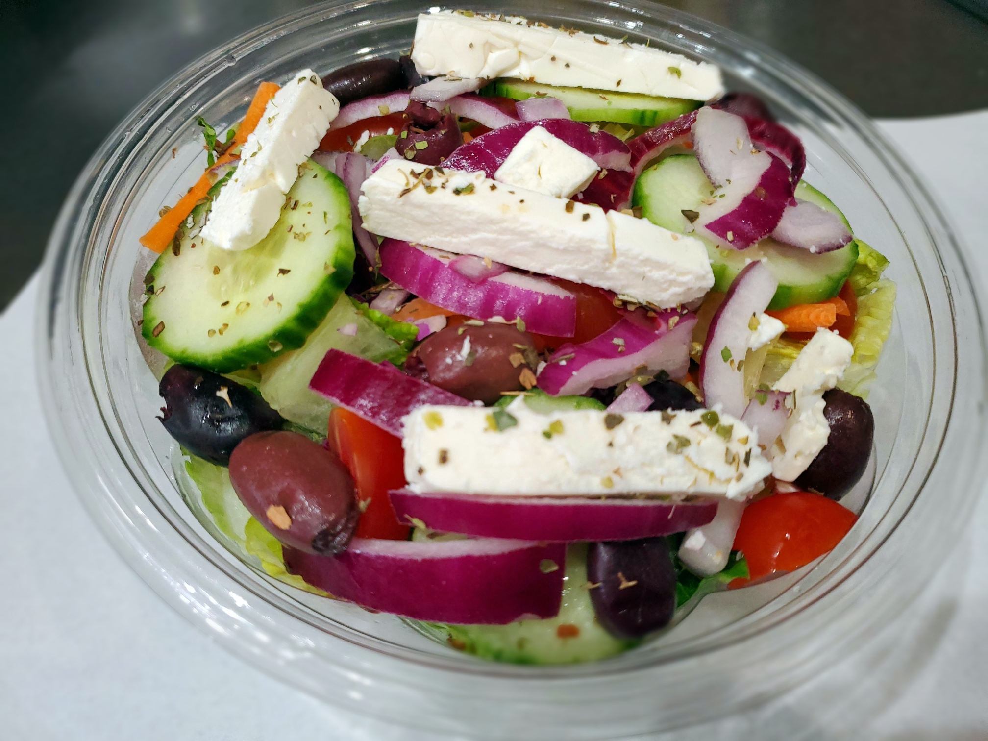Order Greek Salad food online from Famous famiglia pizza store, New York on bringmethat.com