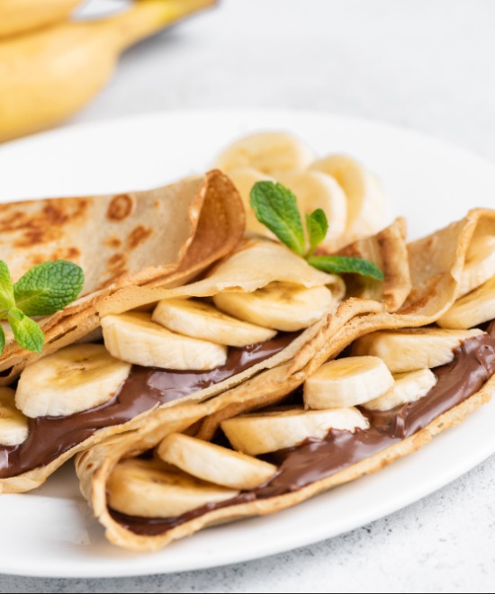 Order Banana Nutella Crepe (Non-Vegan) food online from Curry Sabor store, Whittier on bringmethat.com