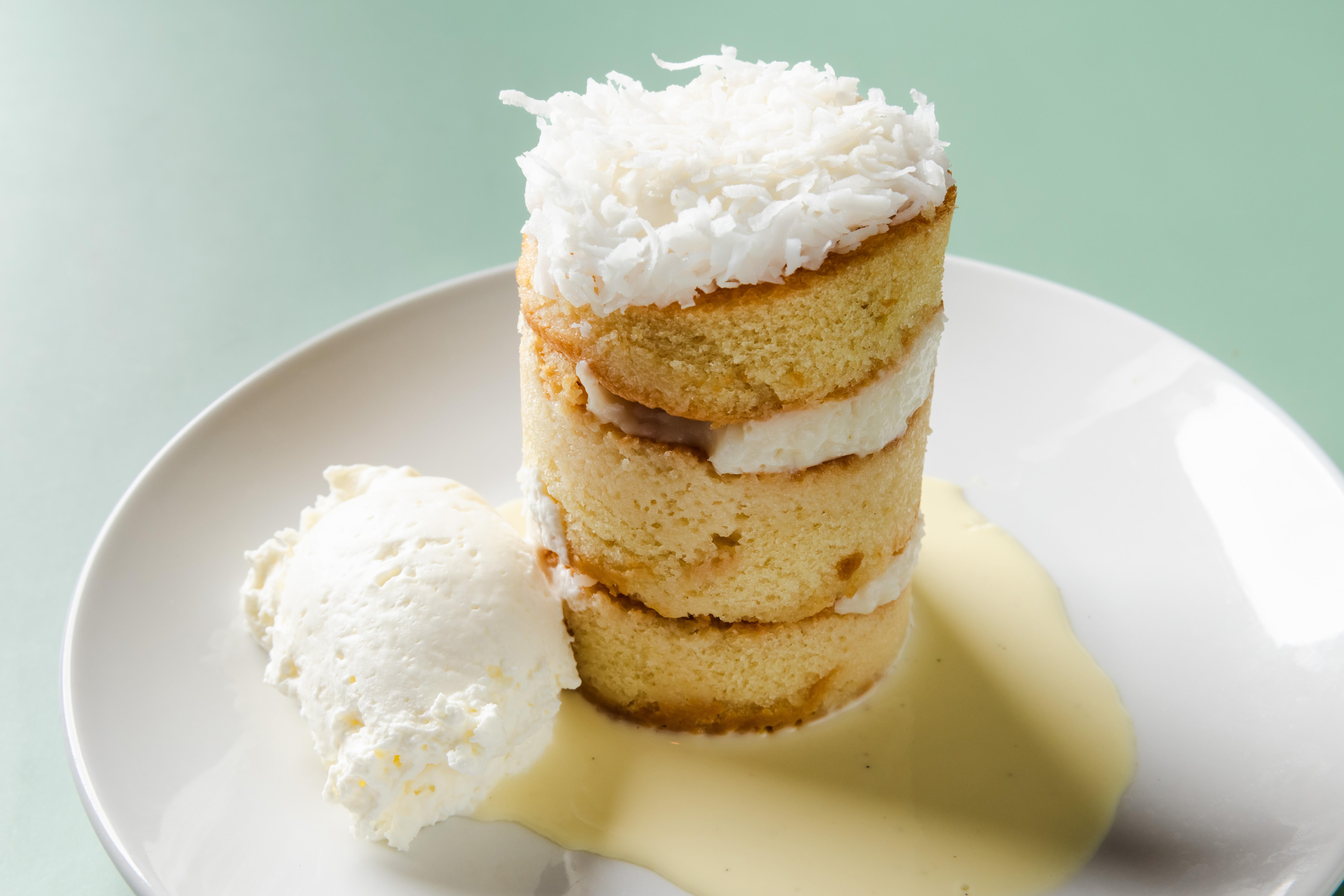 Order Coconut Cake, Creme Anglaise food online from Rooster's Wood-Fired Kitchen -Uptown store, Charlotte on bringmethat.com