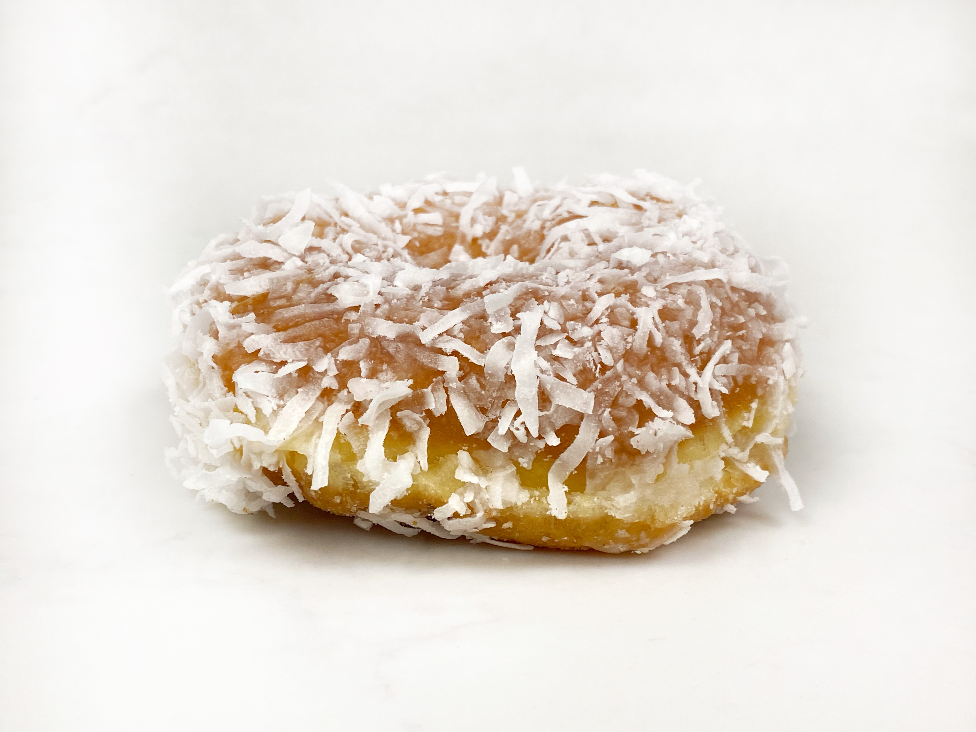 Order Vegan Coconut Raised Donut food online from The Donuttery store, Huntington Beach on bringmethat.com