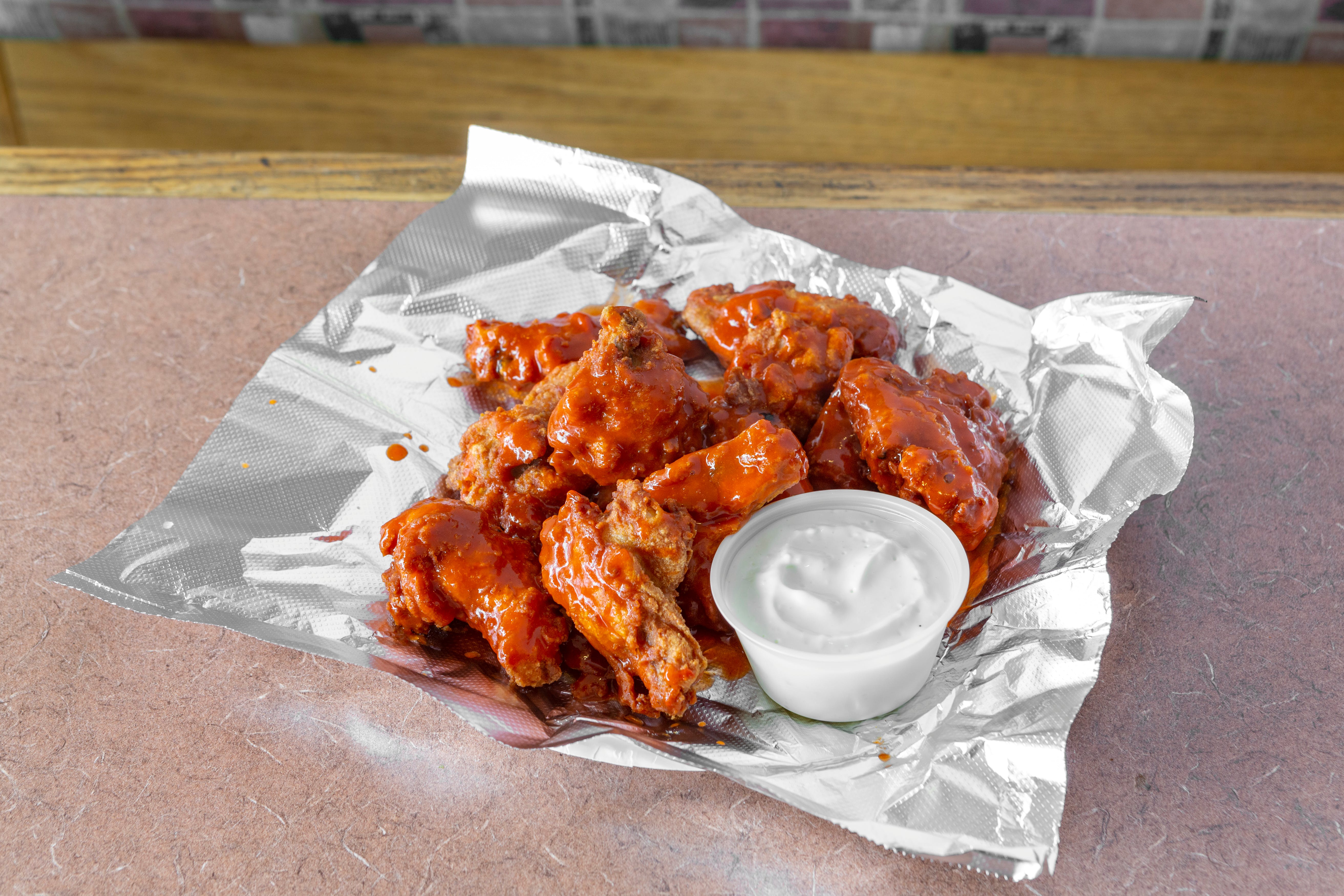 Order Hot & Spicy Buffalo Wings - 7 Pieces food online from Wellesley North End store, Wellesley on bringmethat.com