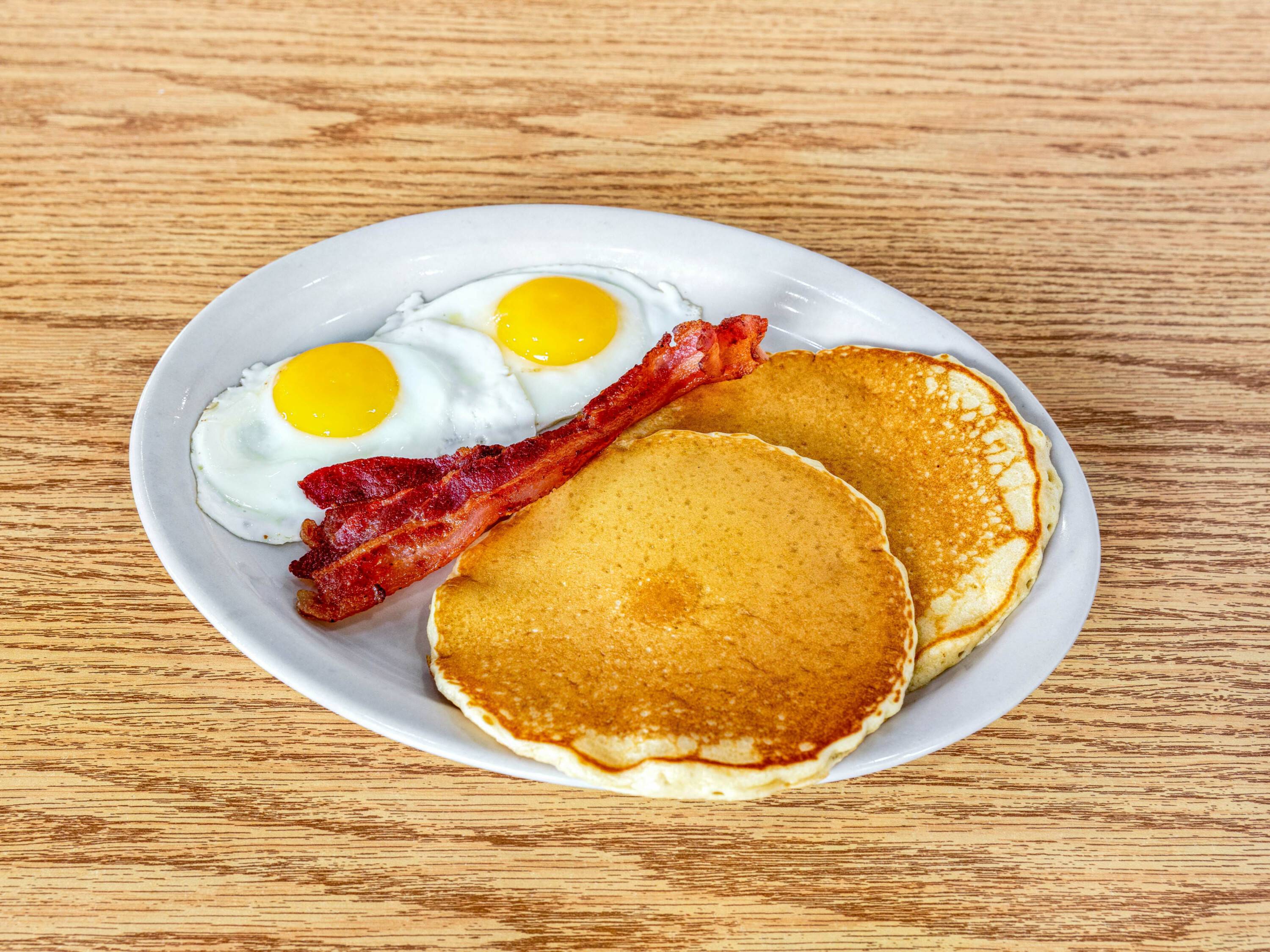 Order 2 Piece Pancakes with Eggs and Bacon food online from La Coronela Mexican Restaurant store, San Antonio on bringmethat.com